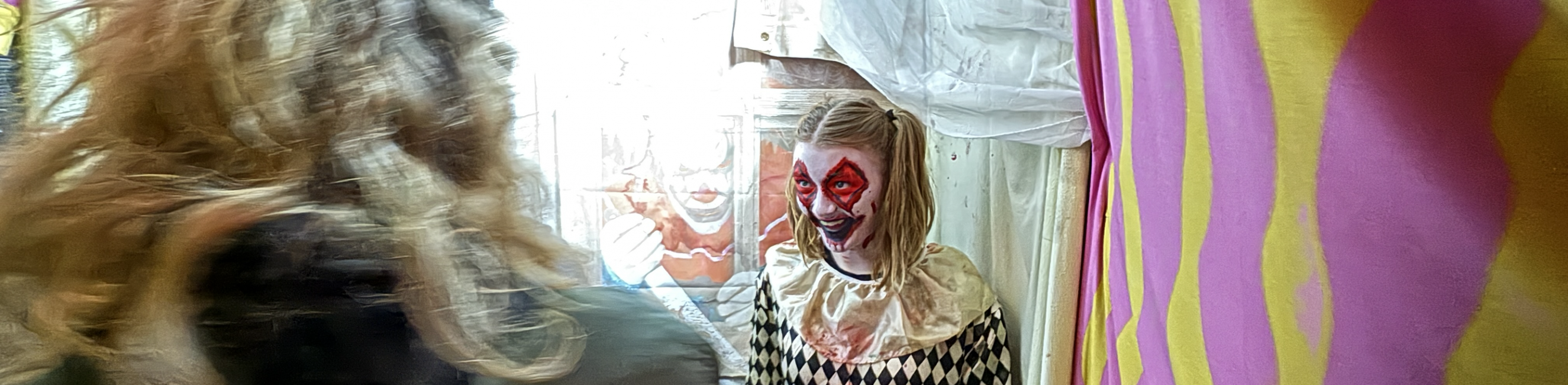 Performing Arts student dressed as a clown and scaring the public