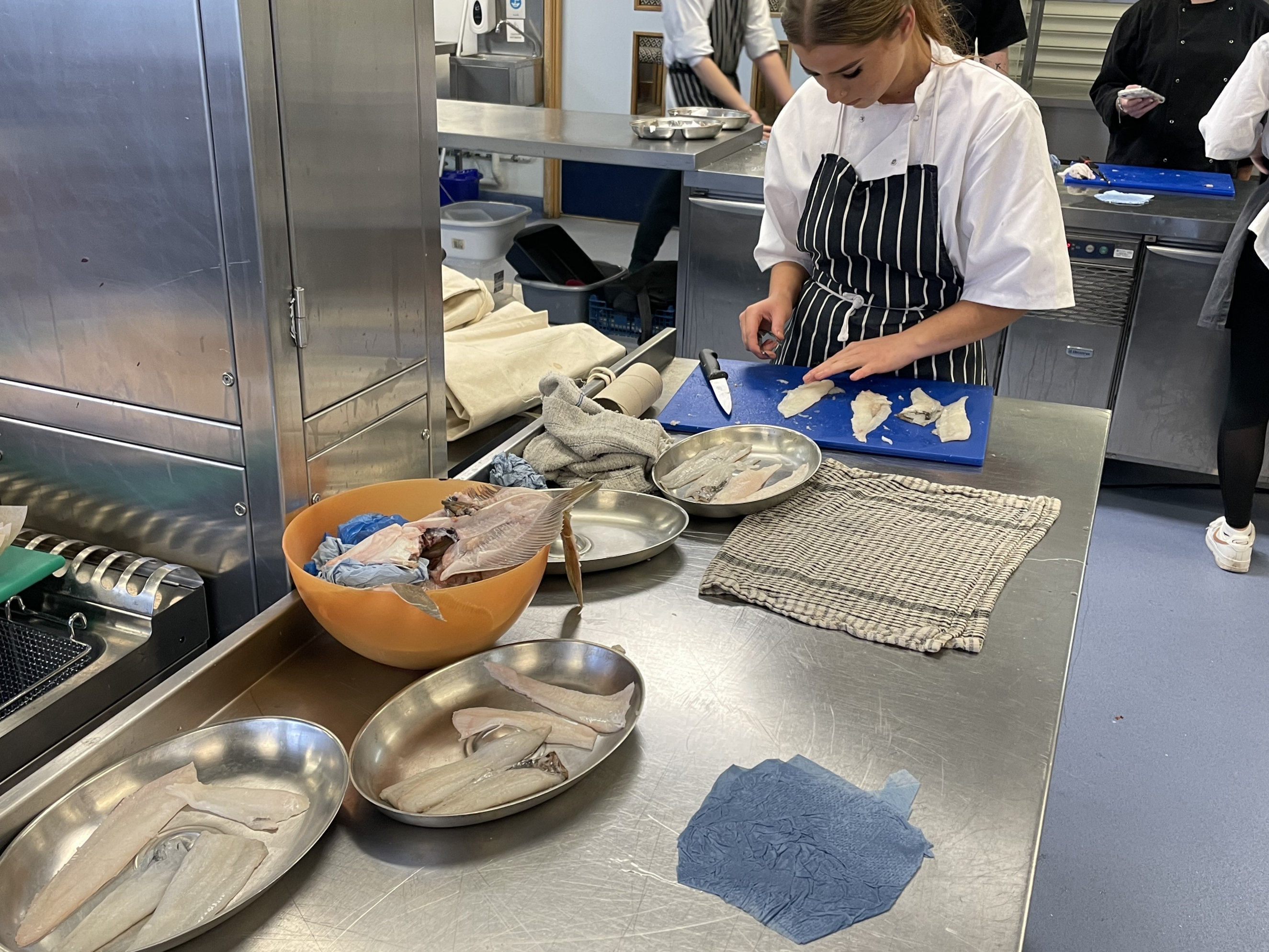 Student cutting up fish during Thatcher's Takeover