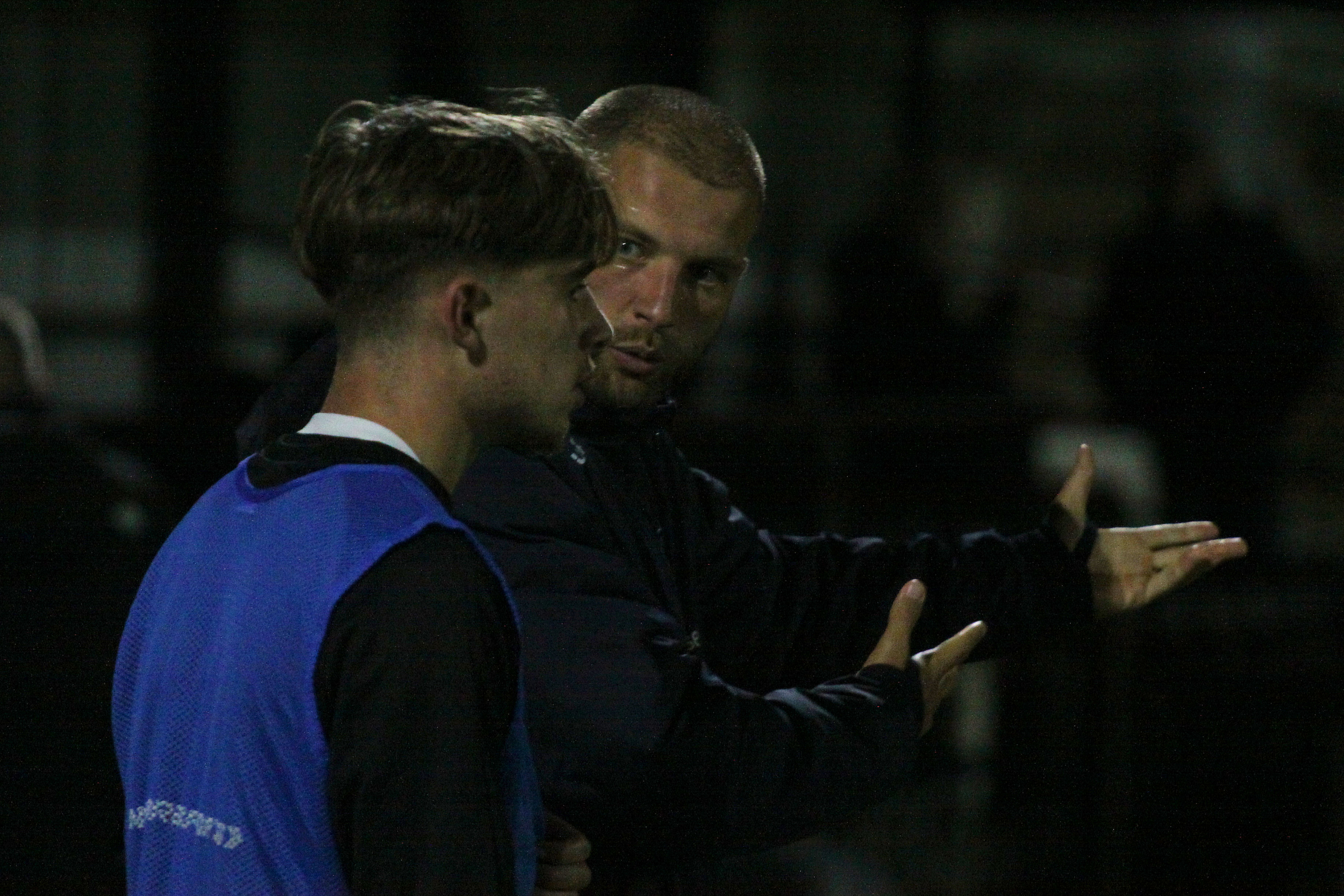 Coach supporting football player