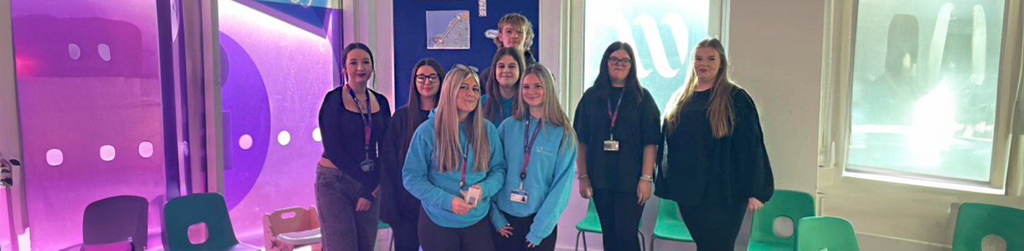 A group of Early Years learners smiling in the early years classroom