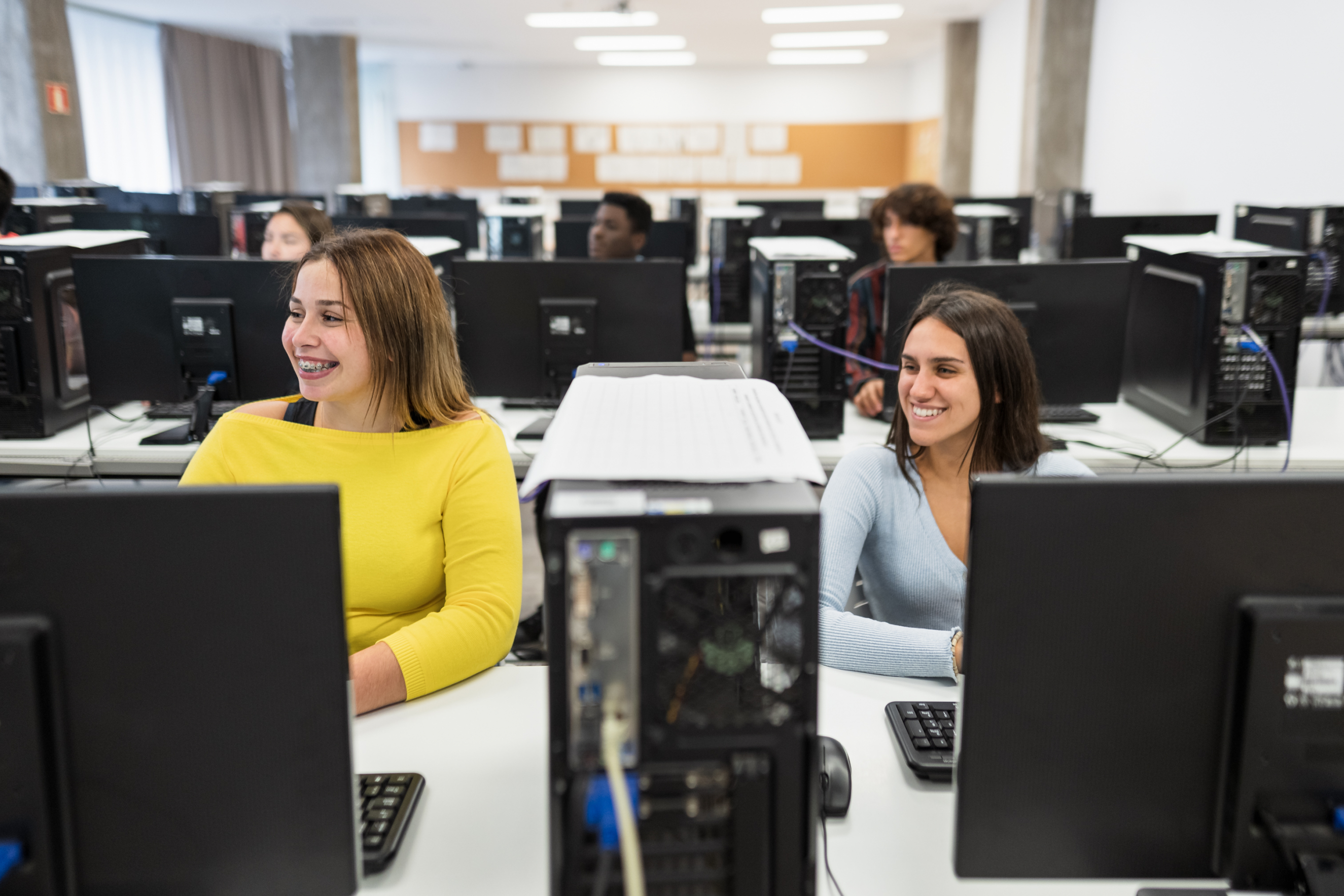 Learners sat smiling at their computers