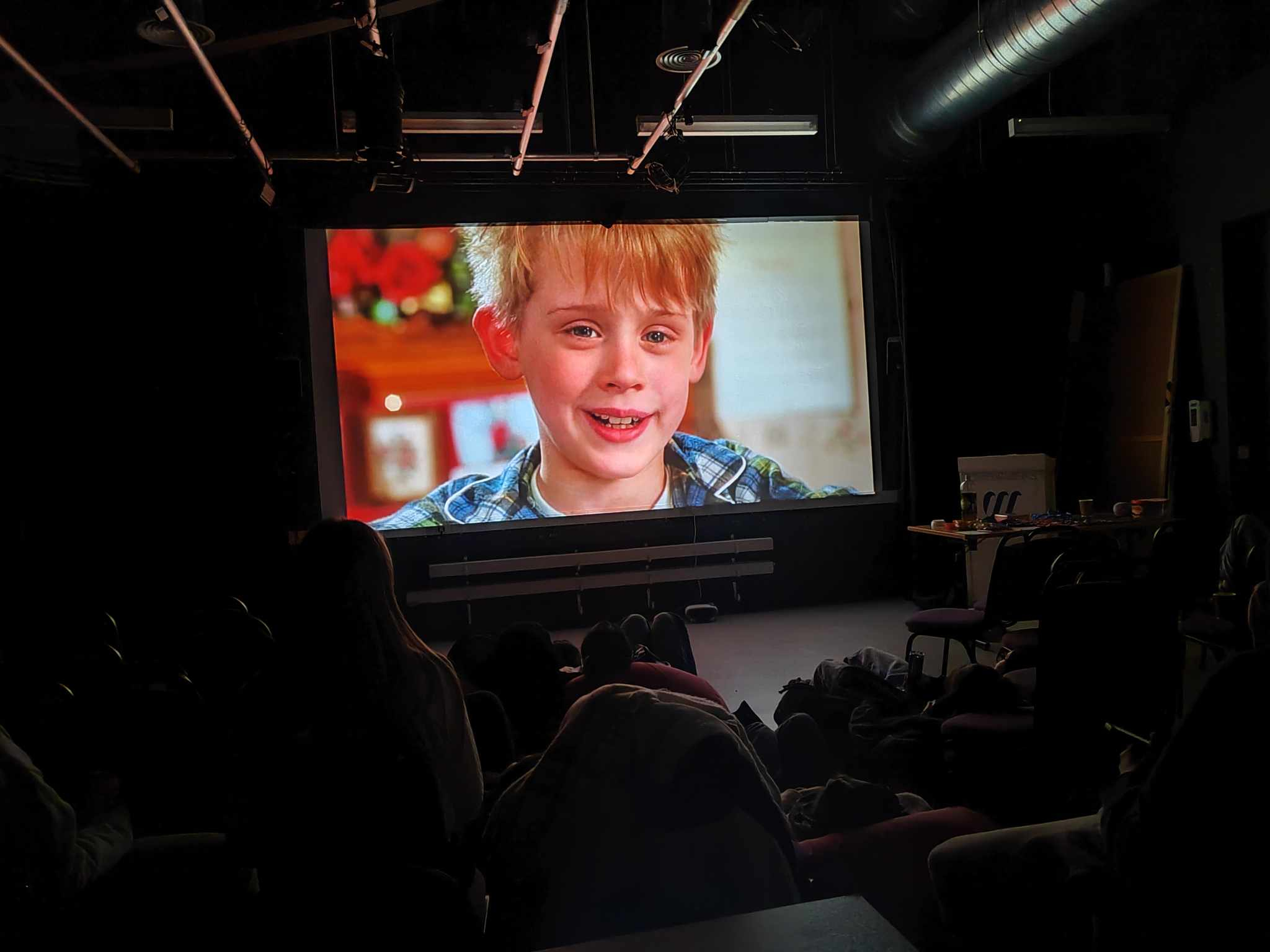 Students watching the film Home Alone on a projector