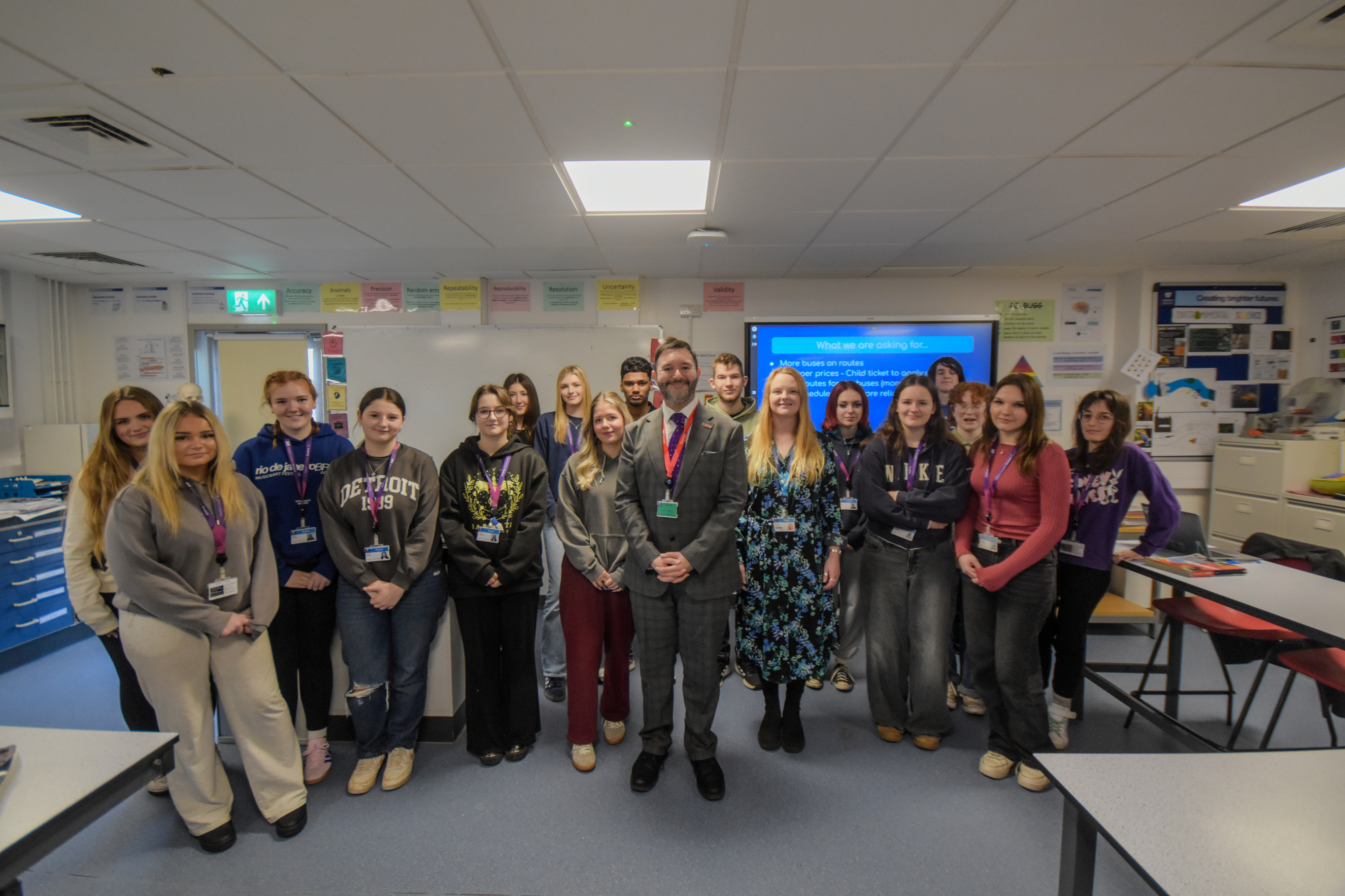 Sadik Al-Hassan standing with the A Level Environmental Health students