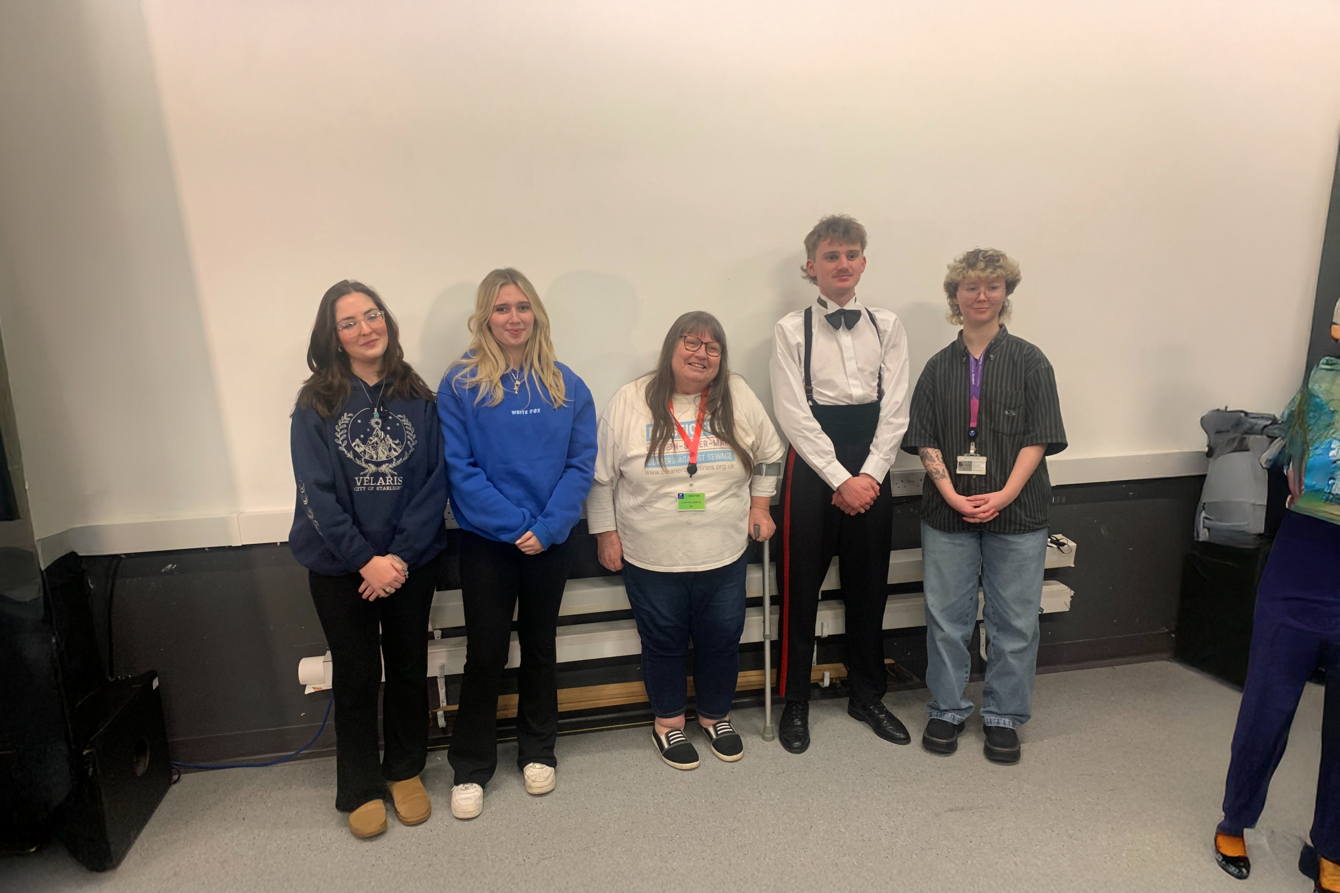 Students standing with a member from the Weston Foodbank 