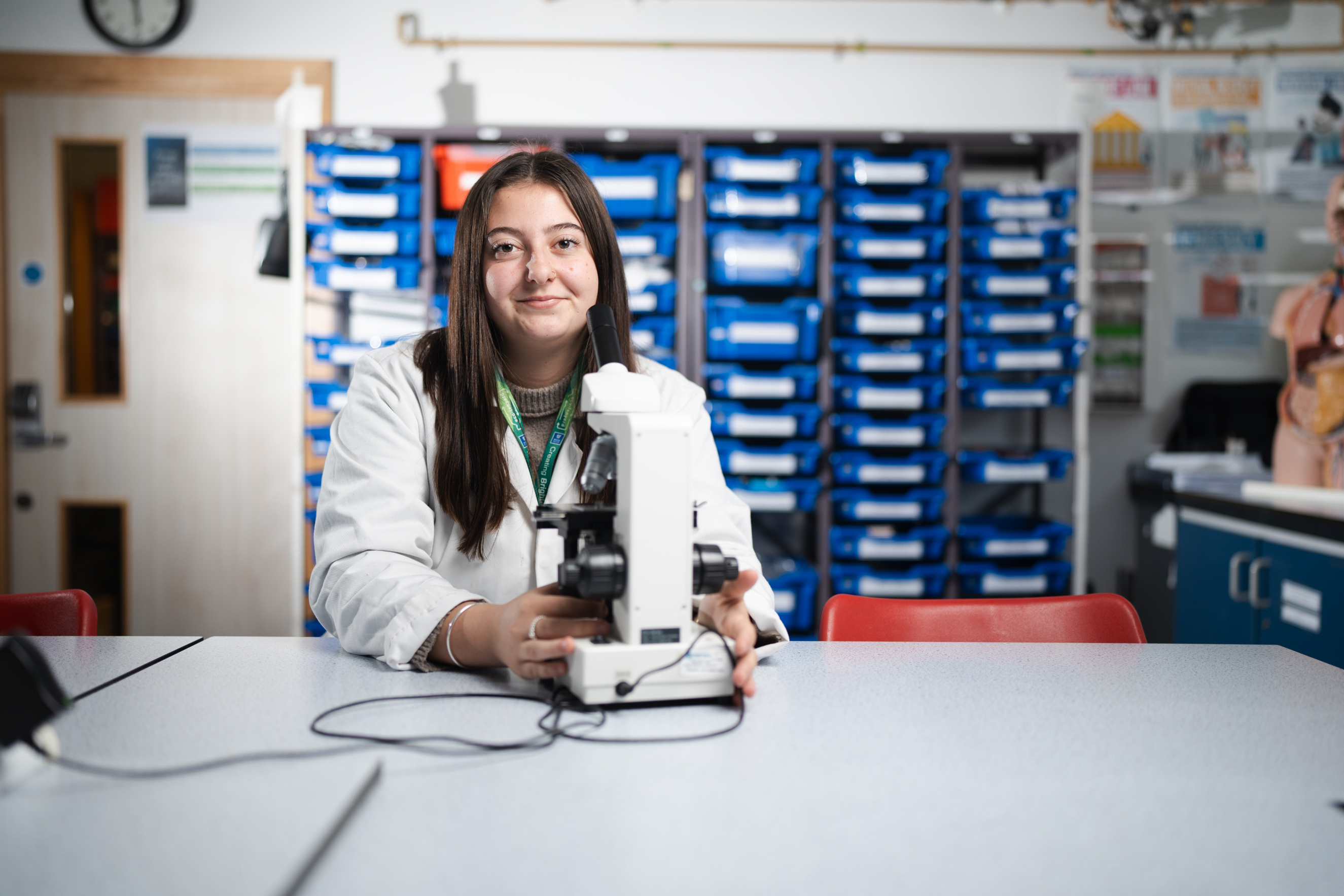 Student in lab smiling at camera