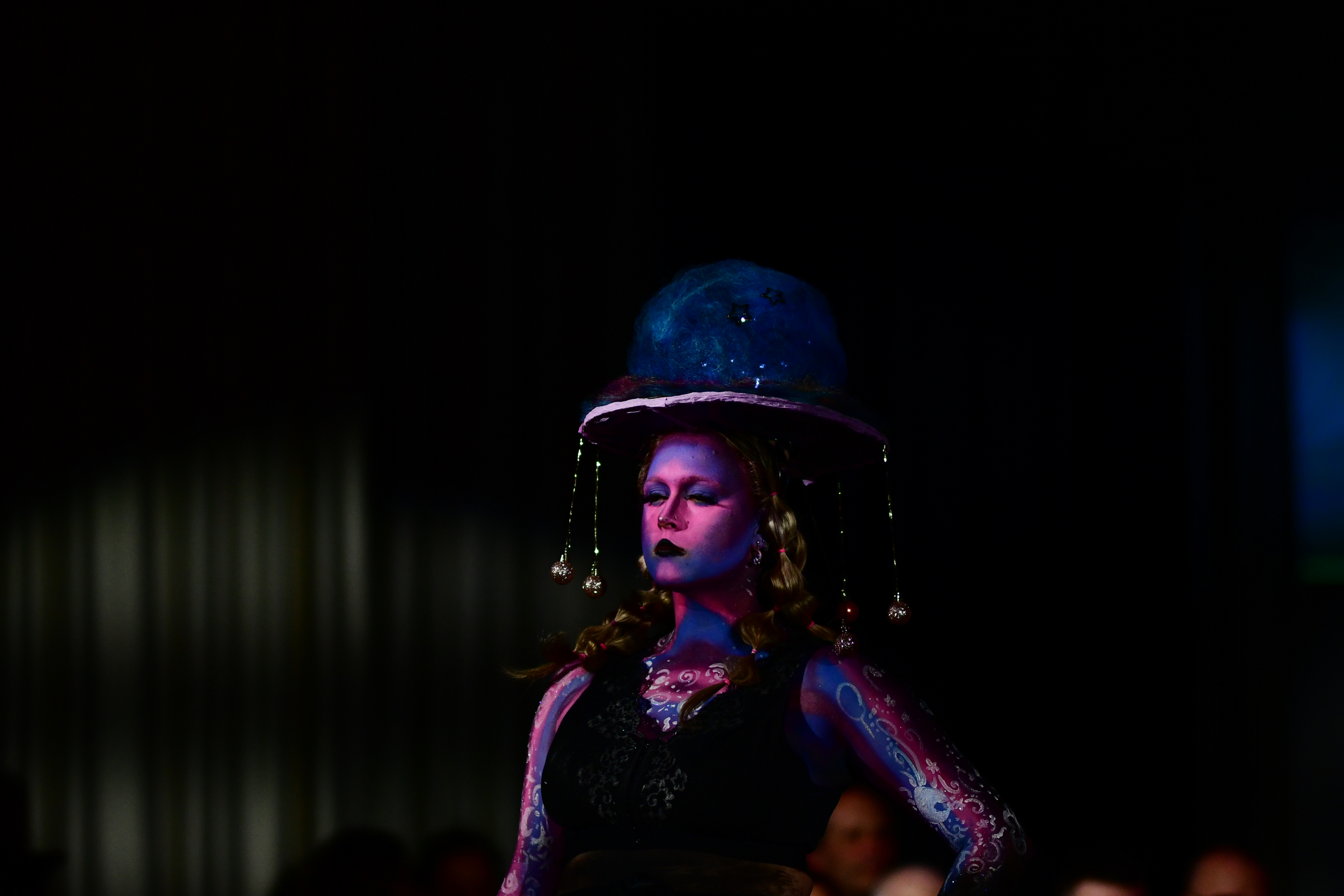 Student modelling a jellyfish-style design with galaxy-themed body paint
