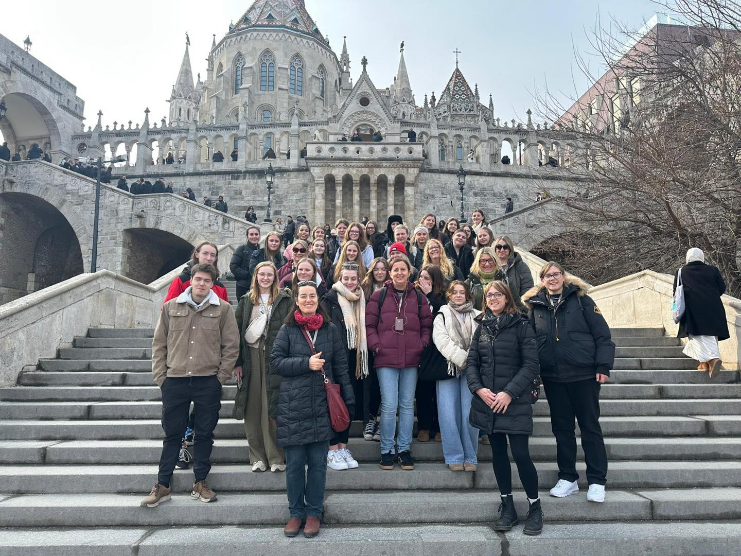 Early Years students standing on steps in front of a big building in Budapest