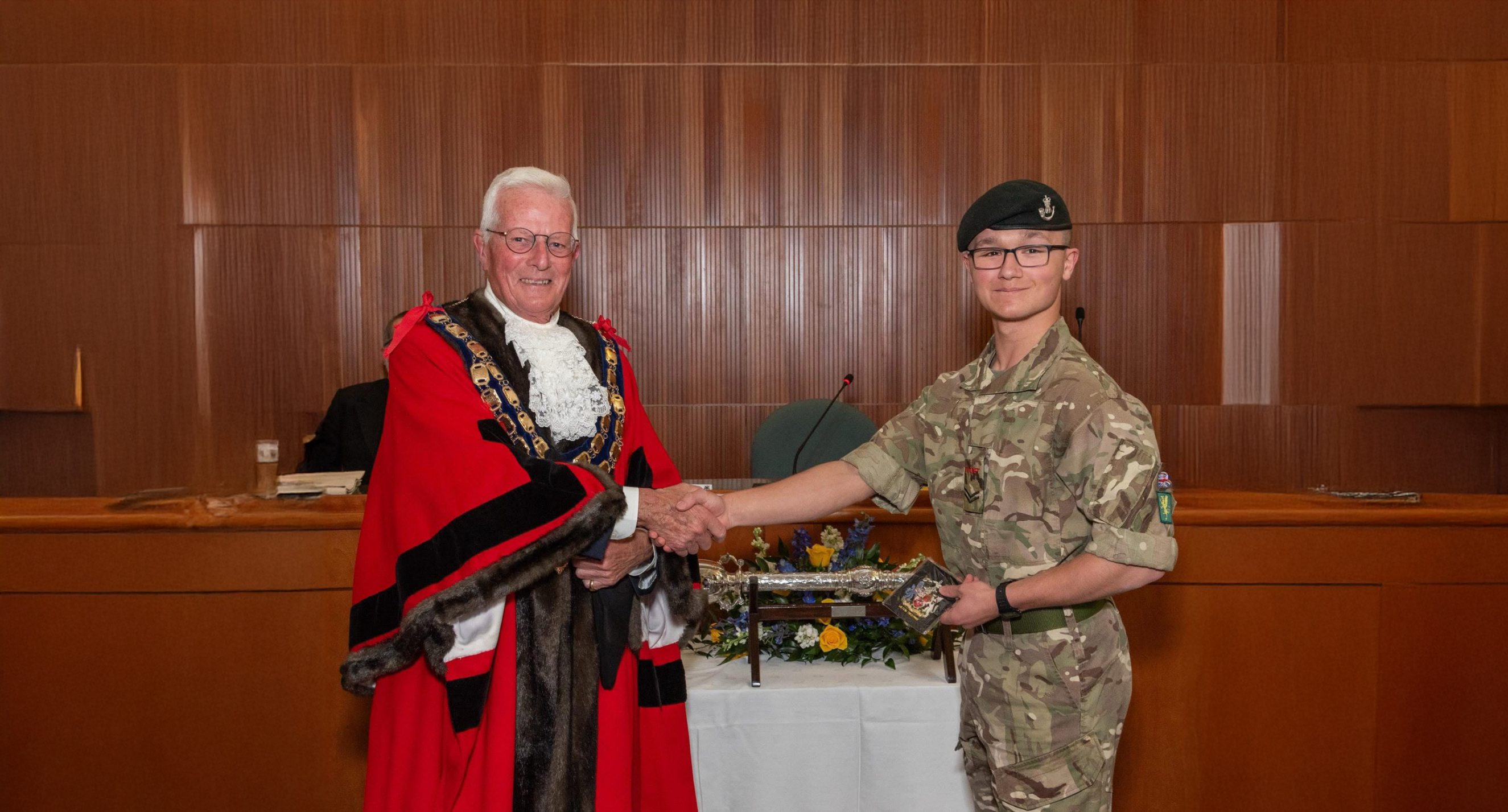 Dean wearing his army cadet uniform shaking hands with the Mayor