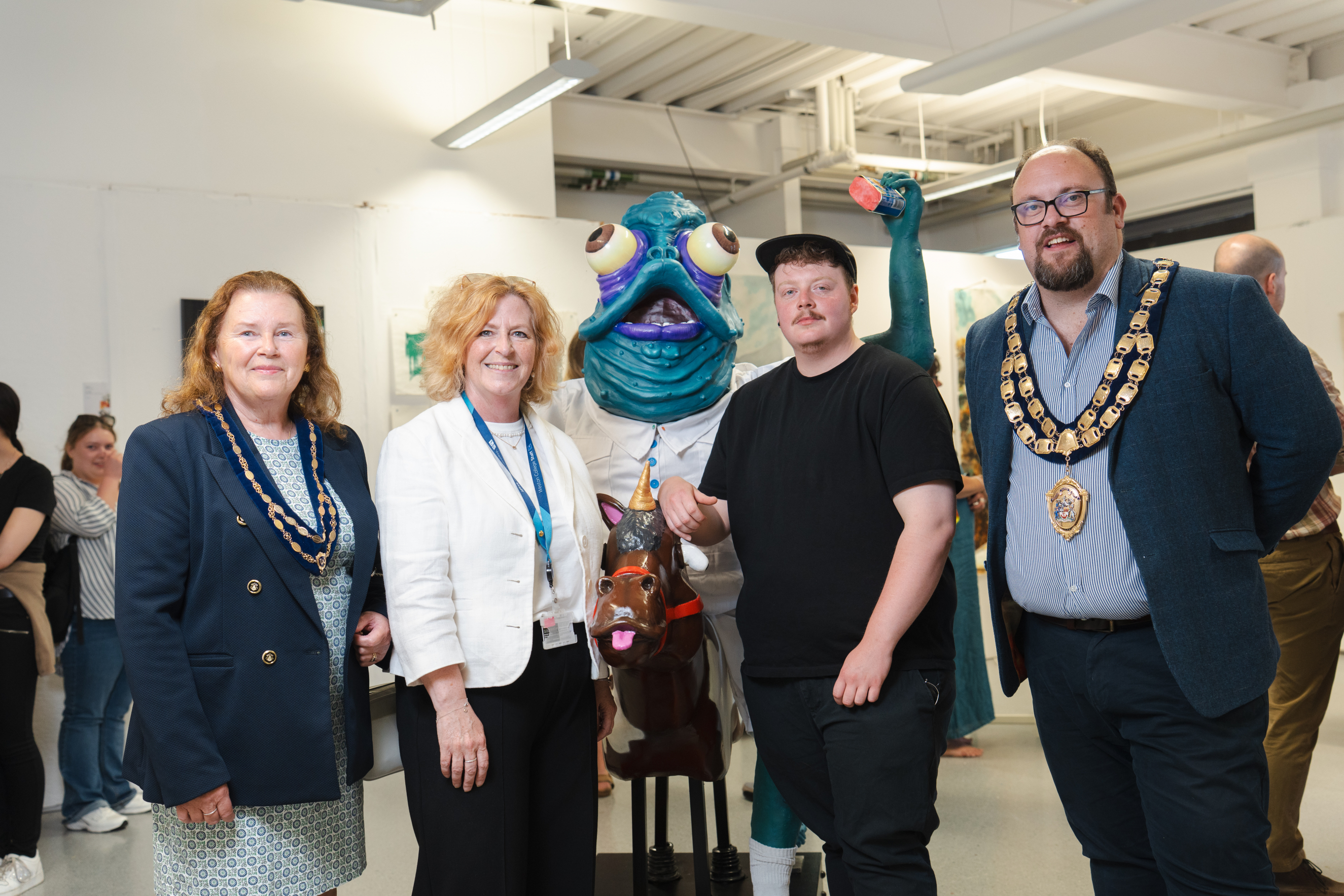 Principal and CEO of Weston College, Pat Jones, and Weston-super-Mare Mayor standing with a student and his work