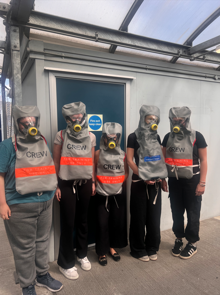 Students wearing lifejackets and oxygen masks