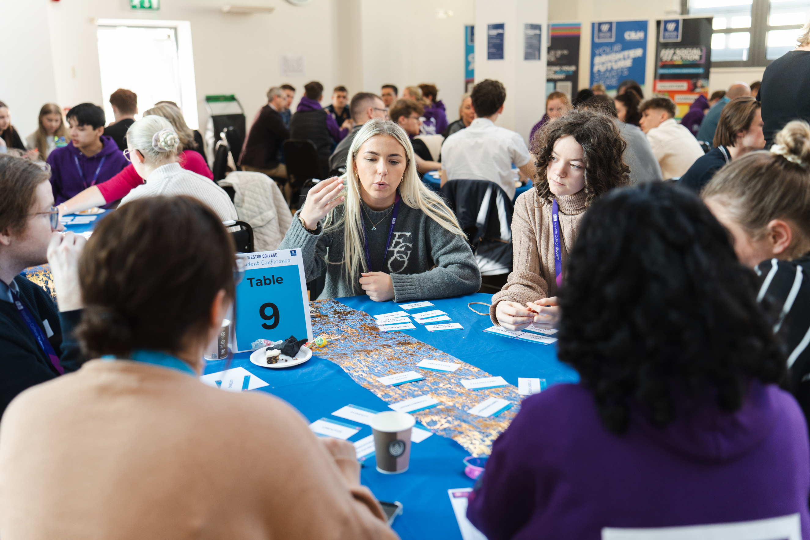 Student conference, learners engaging sat at a table