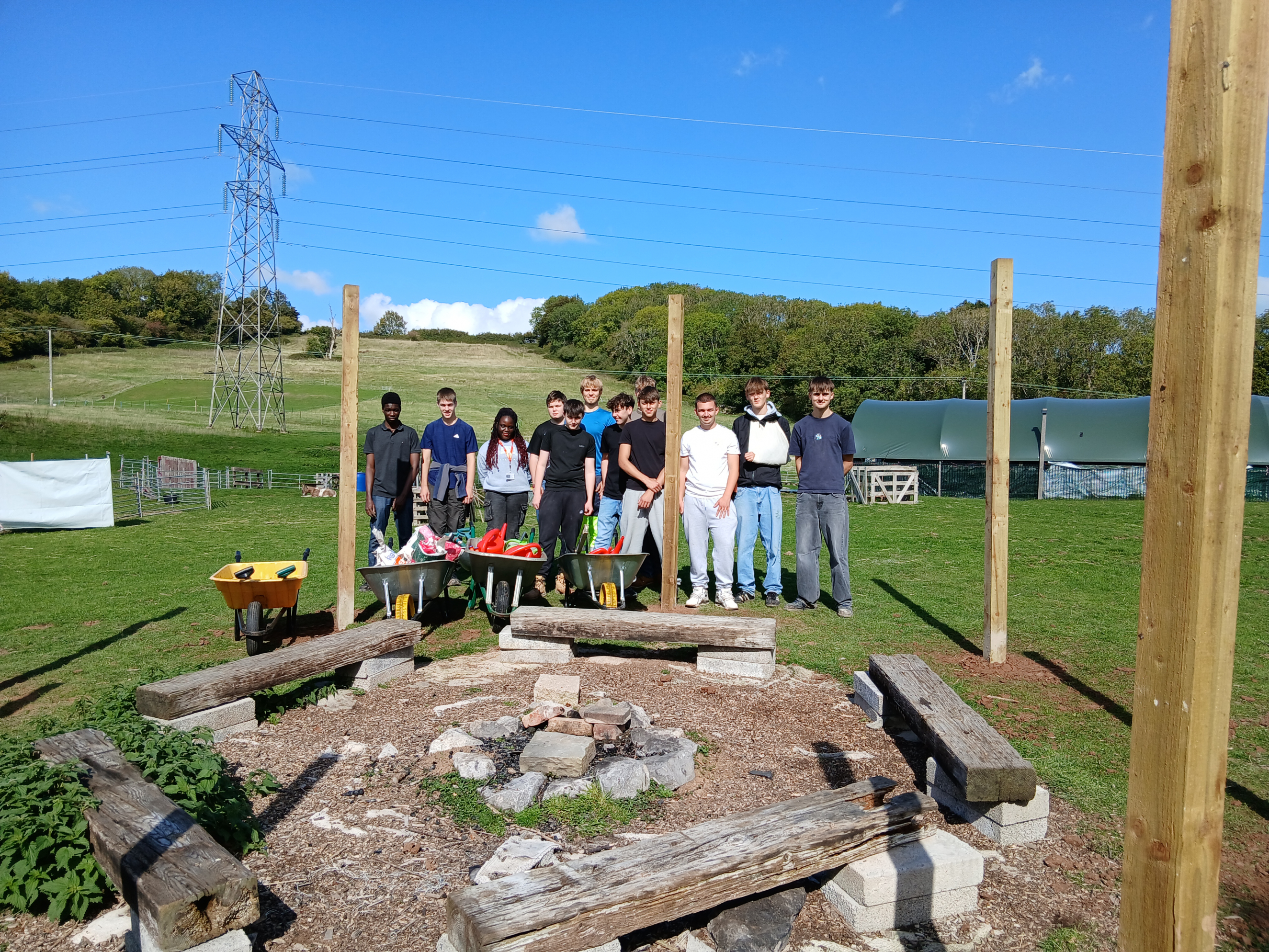 Construction group photo standing by the wooden posts they inserted