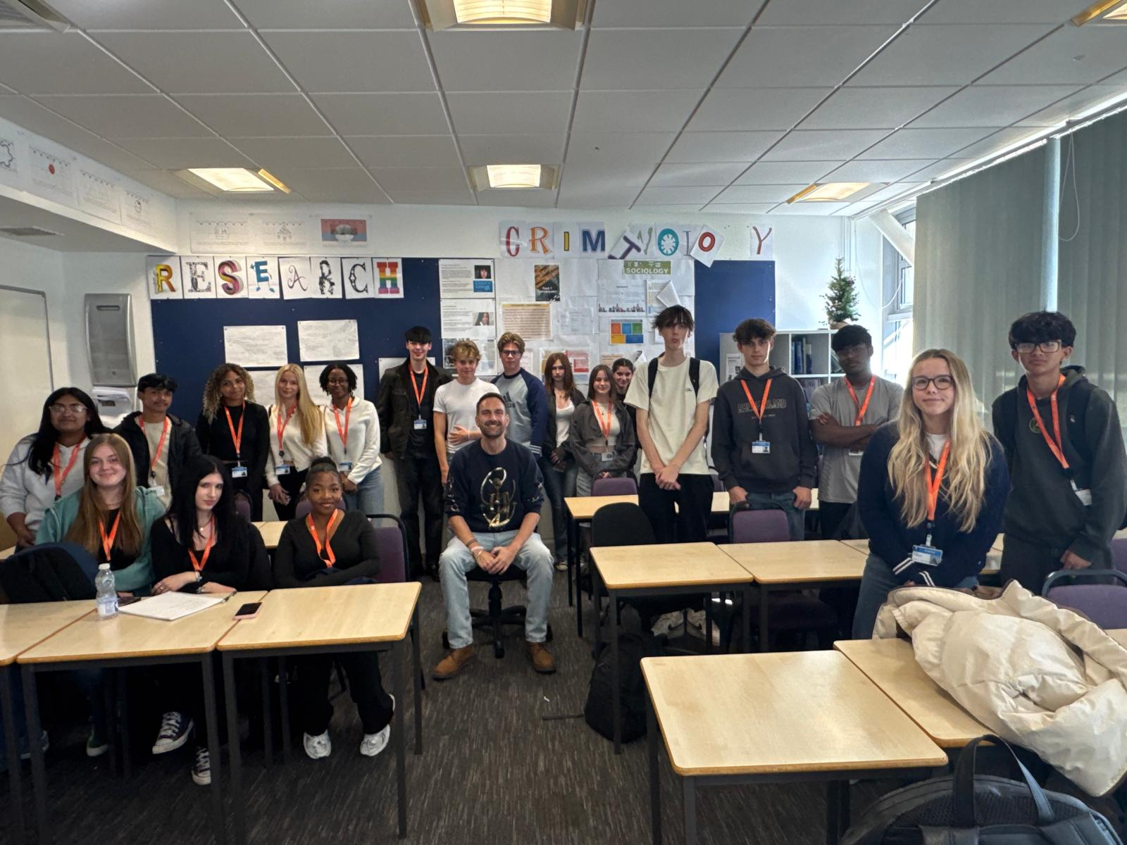 Dan Aldridge and Politics students smiling in classroom