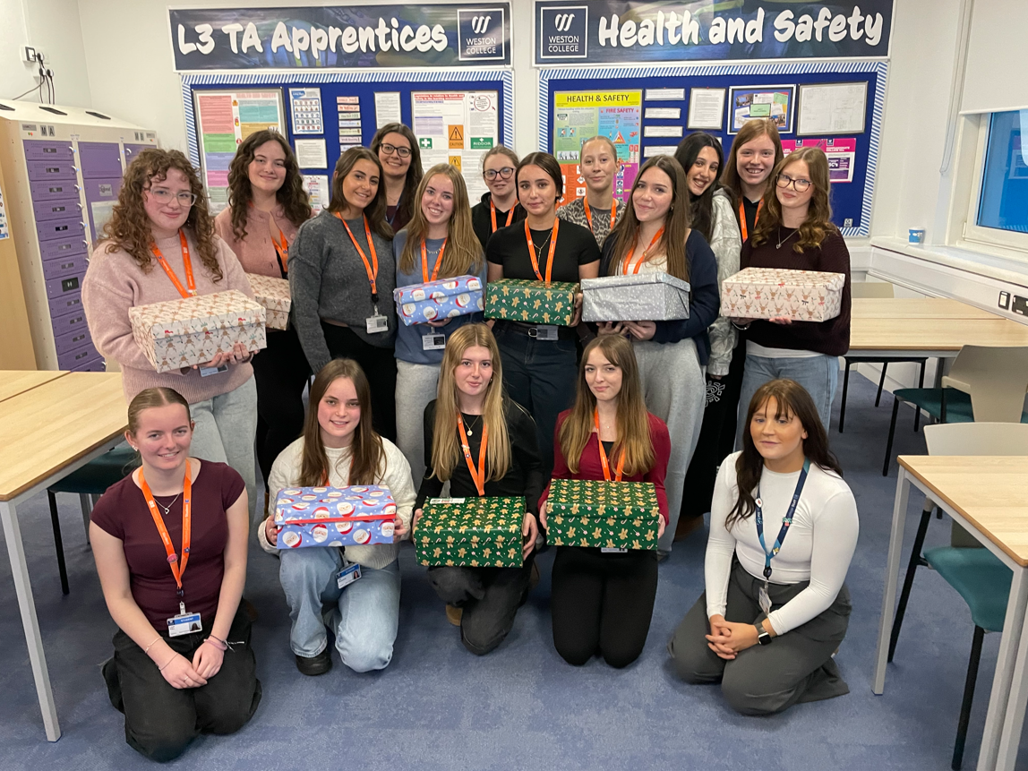 Early Years students holding their shoeboxes