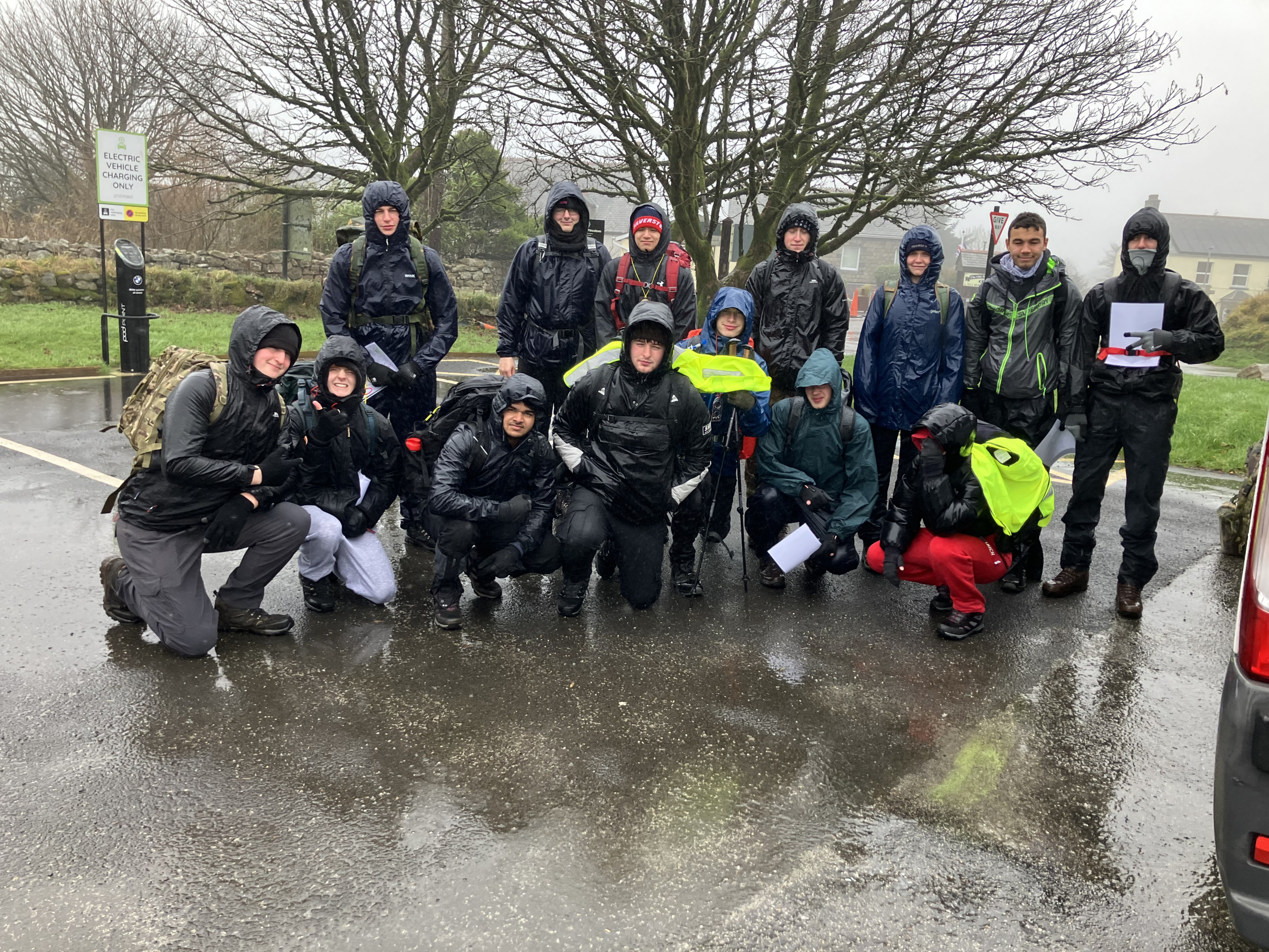 Protective Services students standing smiling soaked in the rain