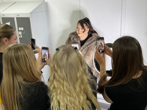 Students taking pictures at the photoshoot