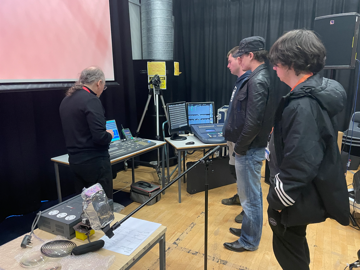 Mike showing students different lighting boards