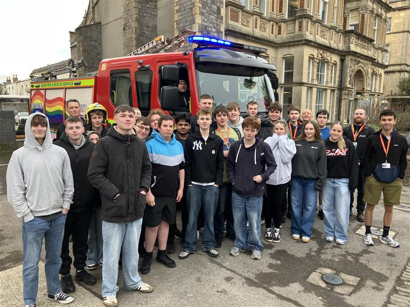 Students standing in front of a fire engine