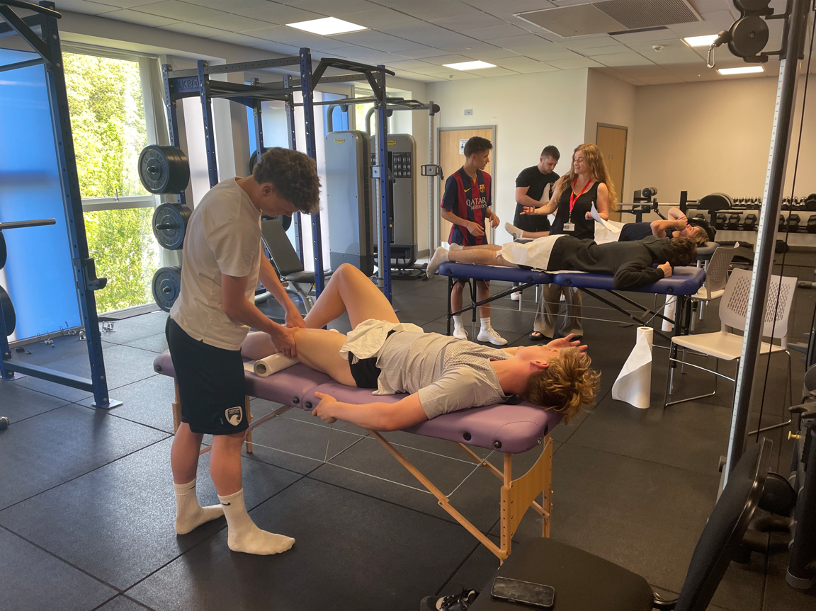 students massaging muscles