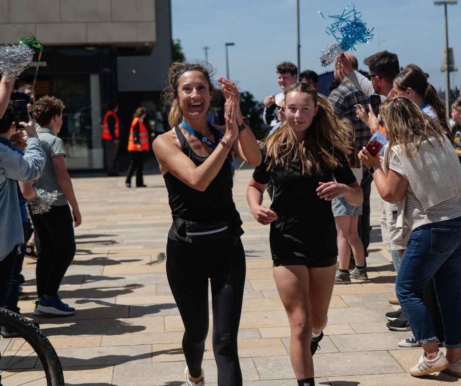 Lecturer and learner finishing 16 mile run
