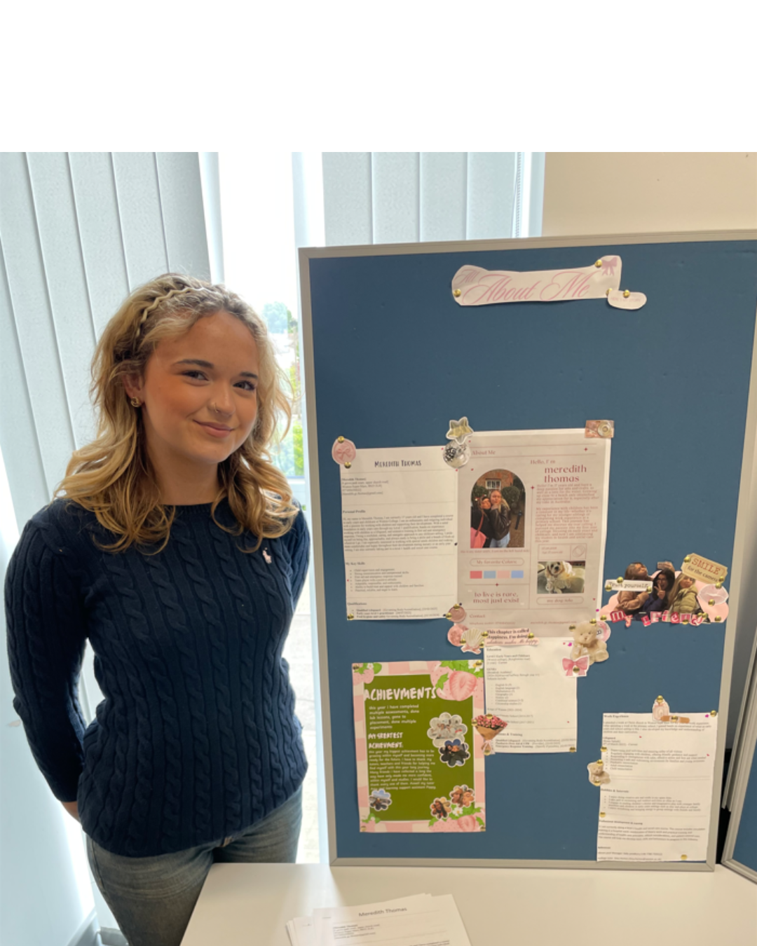 Student stood with her display of work
