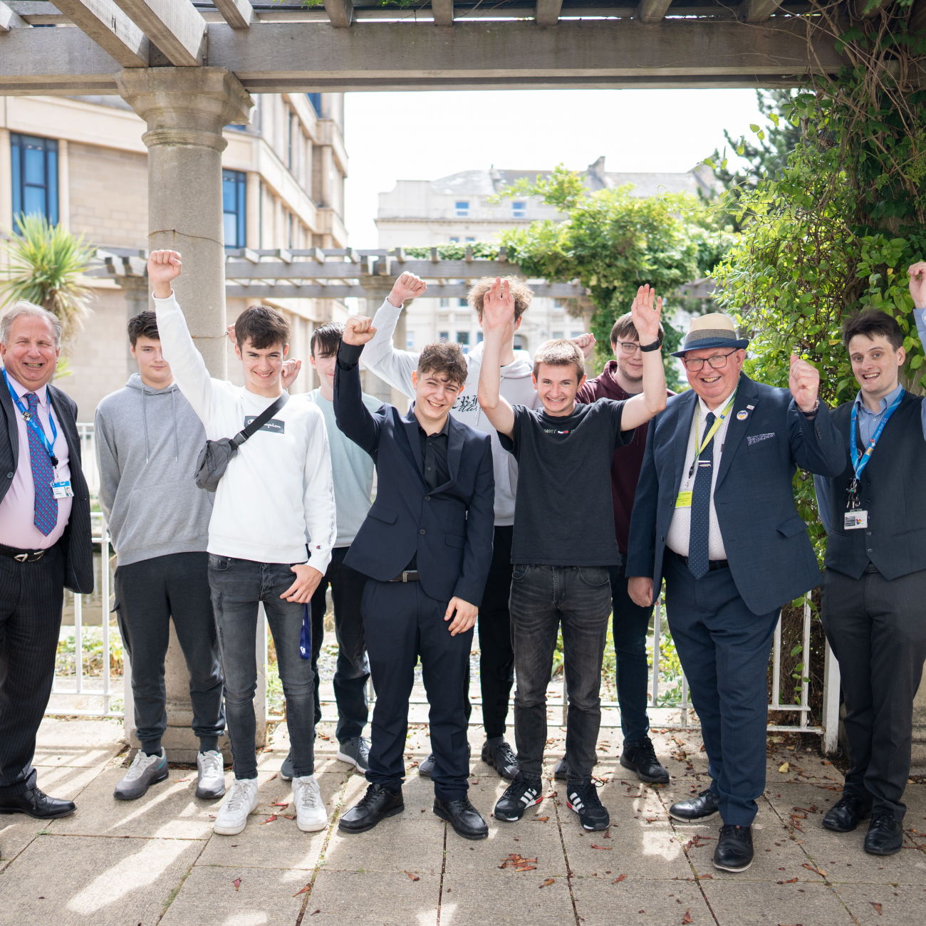 T Level learners cheering with Dr Paul Phillips
