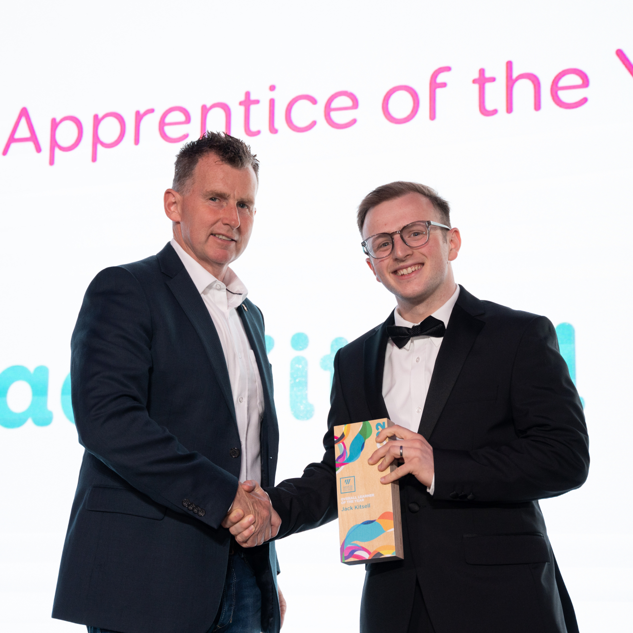 Jack Kitsell shaking hands with Nigel Owen after winning his award