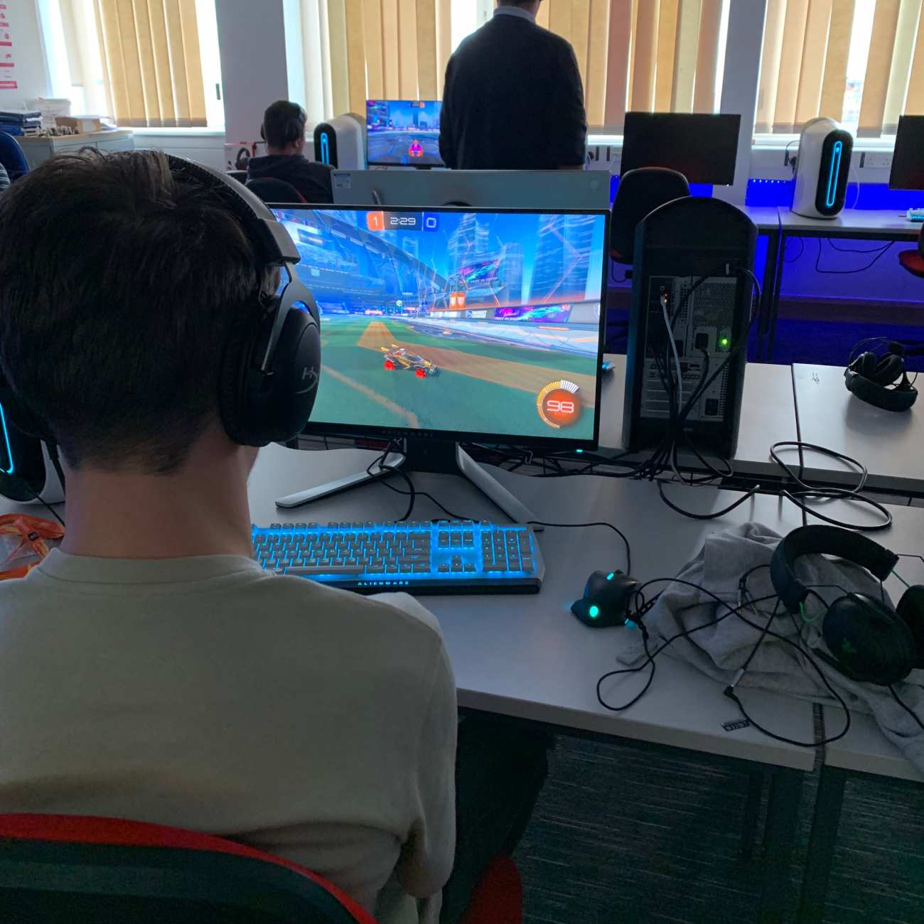 Student playing esports game on computer