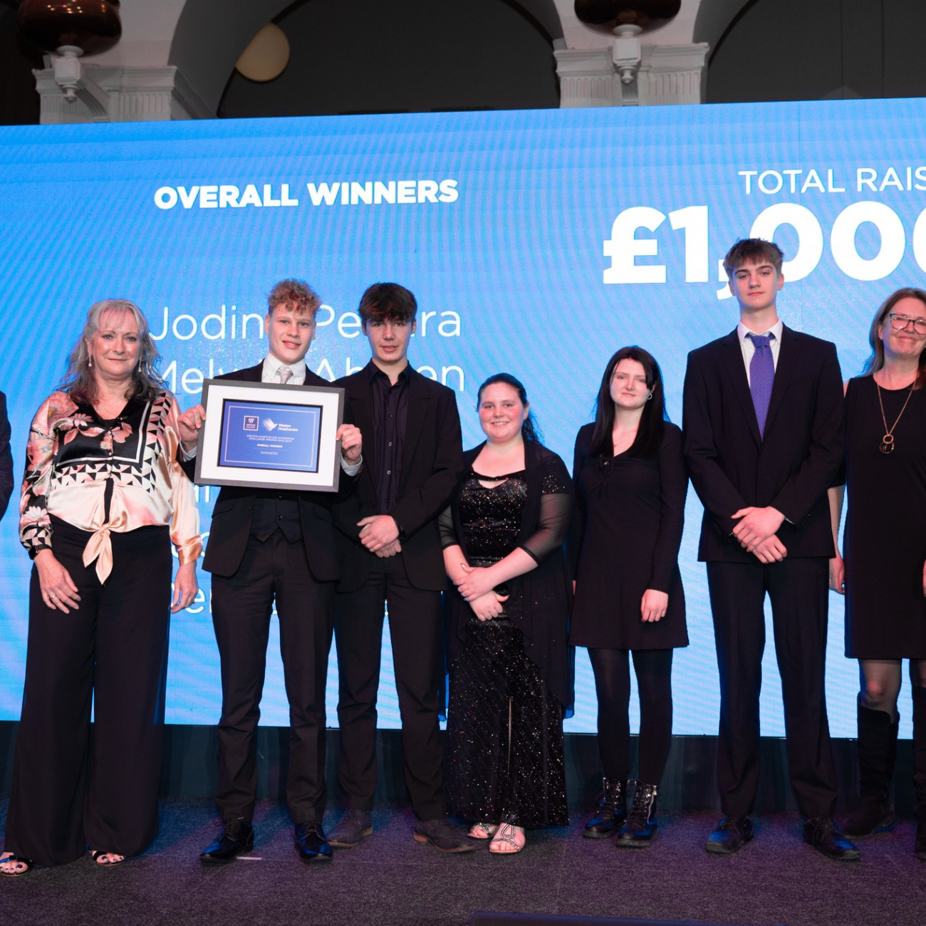 Six learners on stage receiving award for their work with Weston Hospicecare