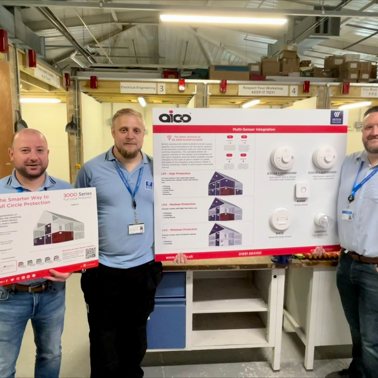 Alex, Lee and Andy holding Aico promotional board