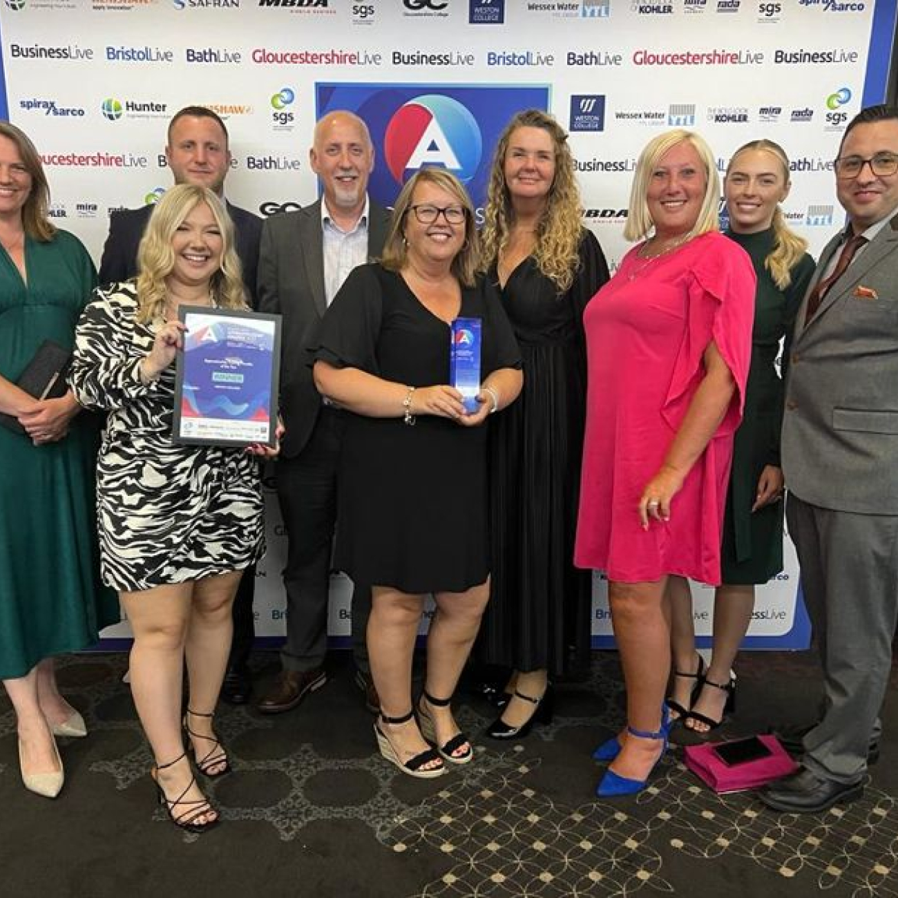 Weston College staff posing with award