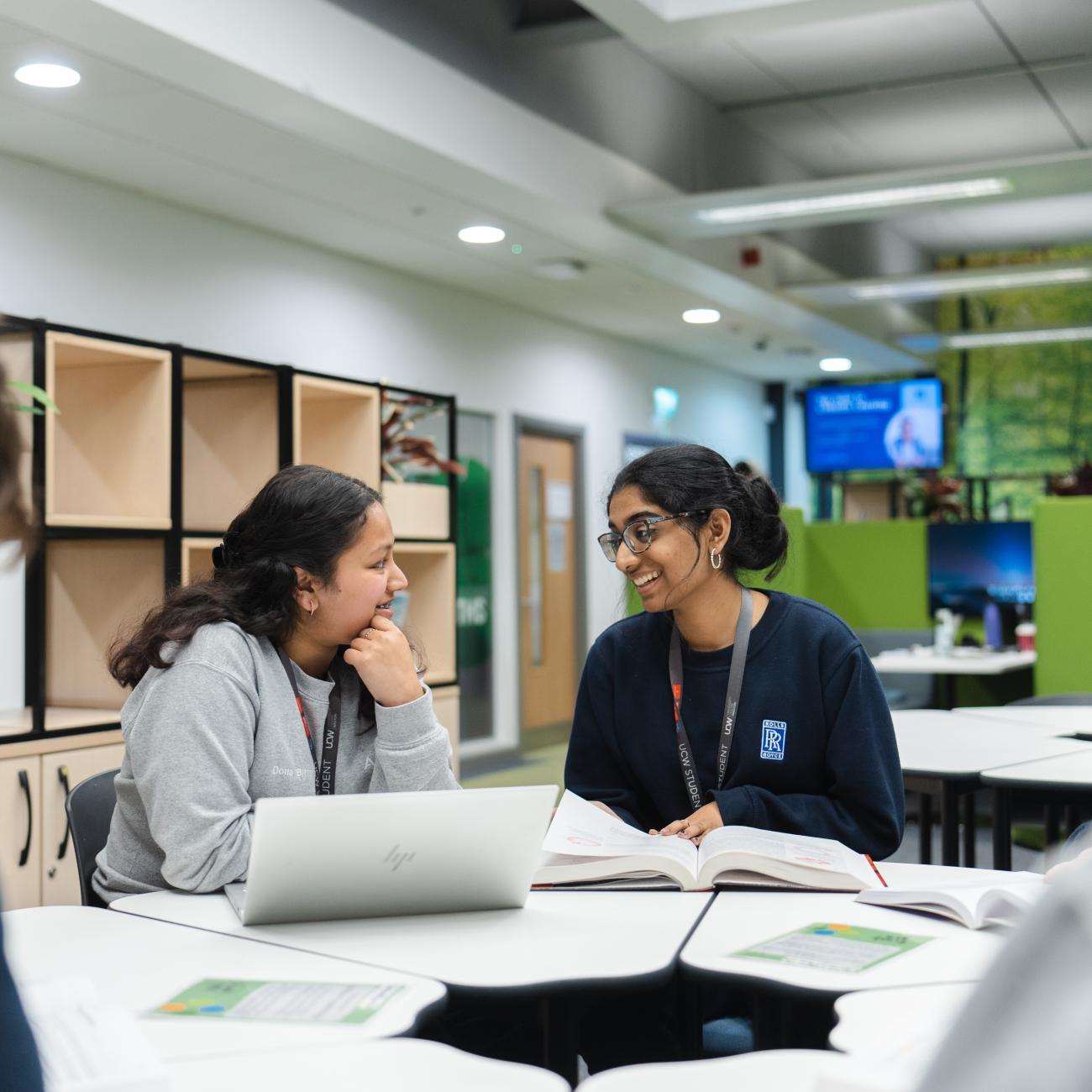 students smiling studying in Library at weston college