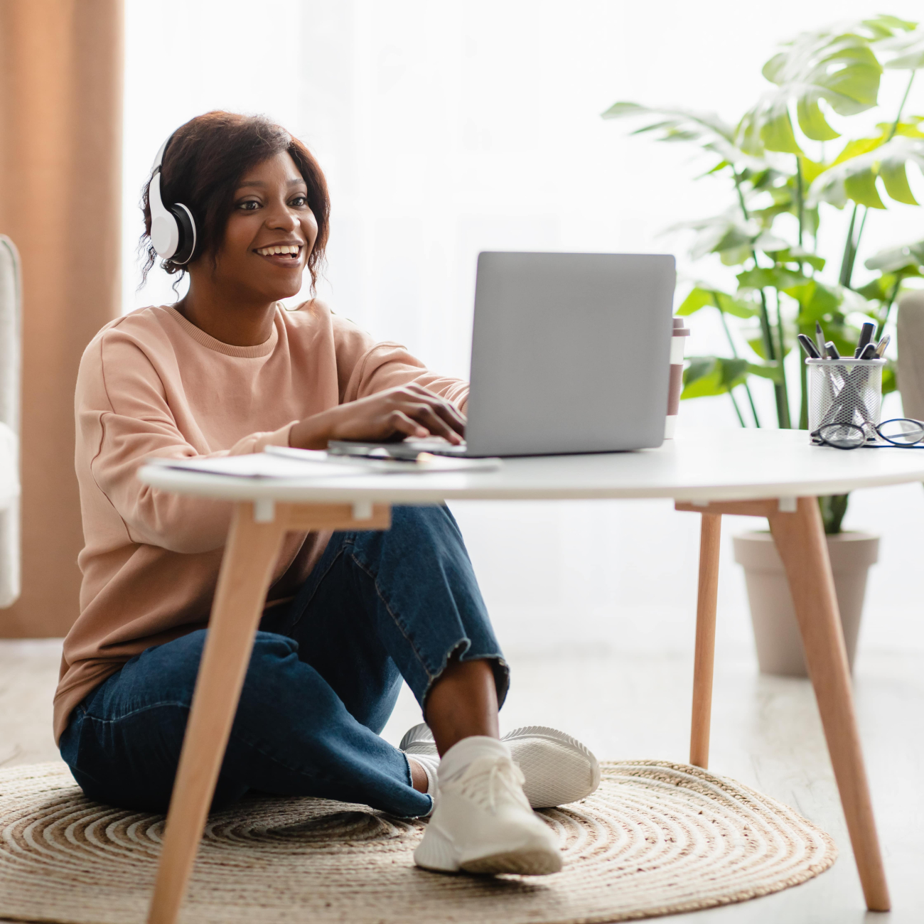 woman using laptop wearing headphones