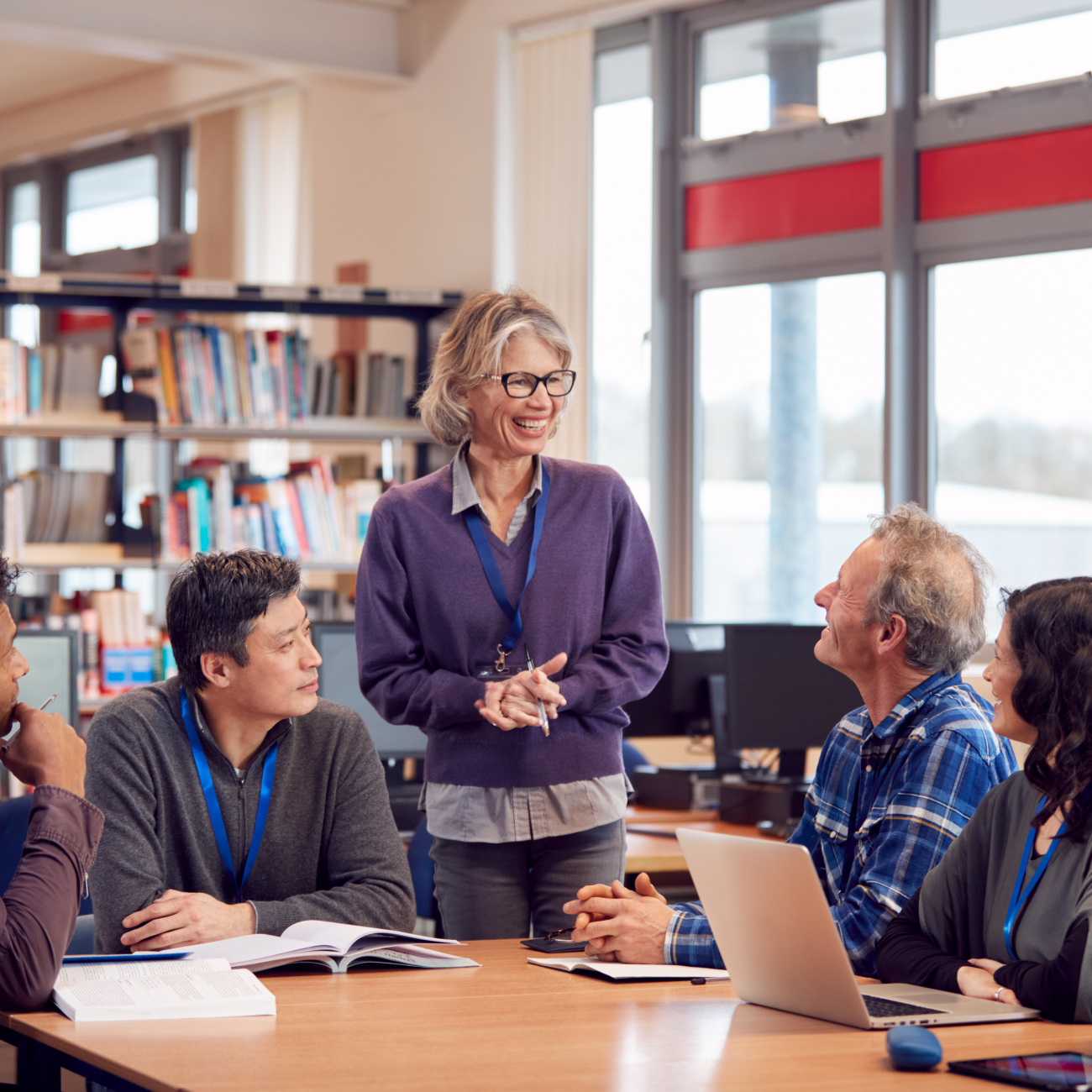 teacher with adult learners in classroom