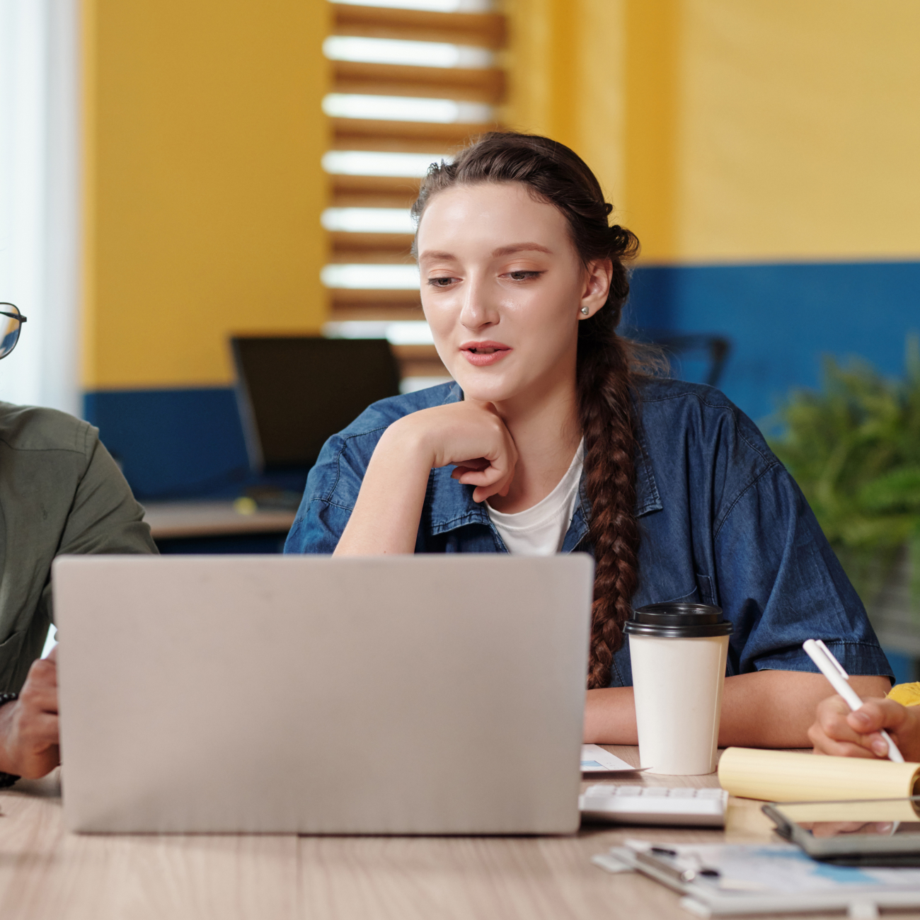Three people having conversation in classroom