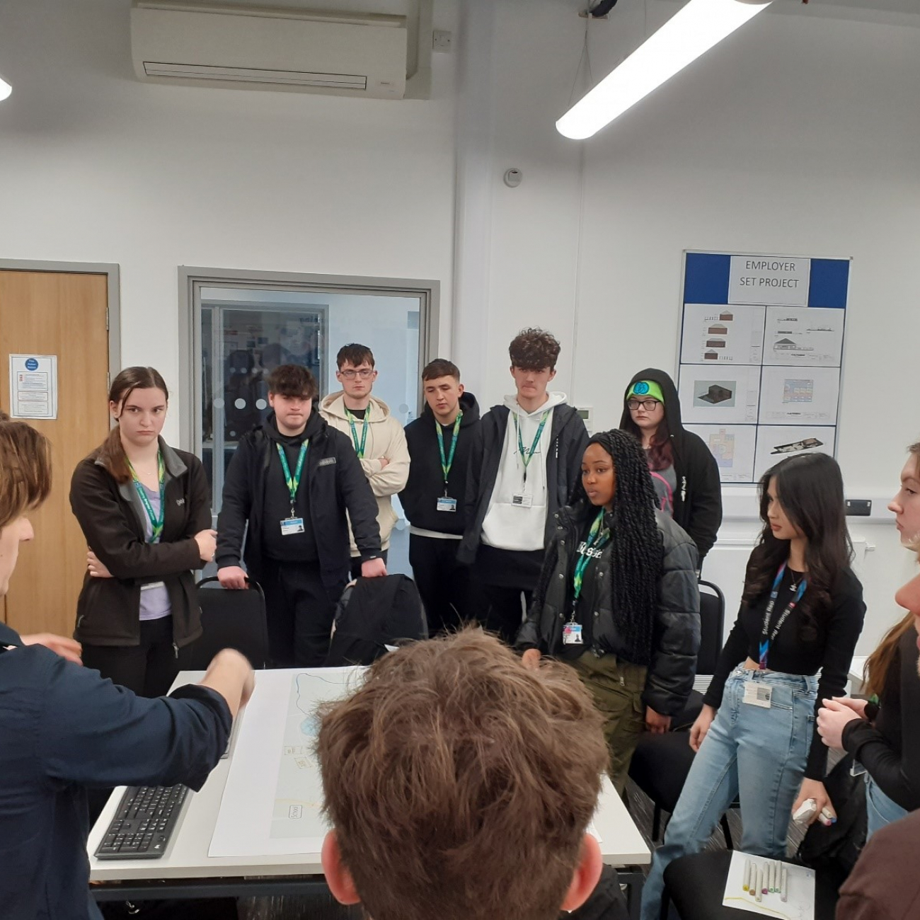 Learners standing and discussing a task