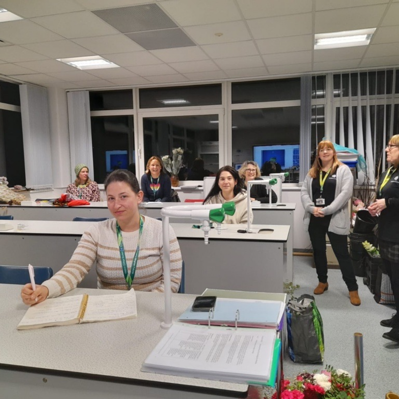 Floristry learners sitting at desks while learning about a floristry industry