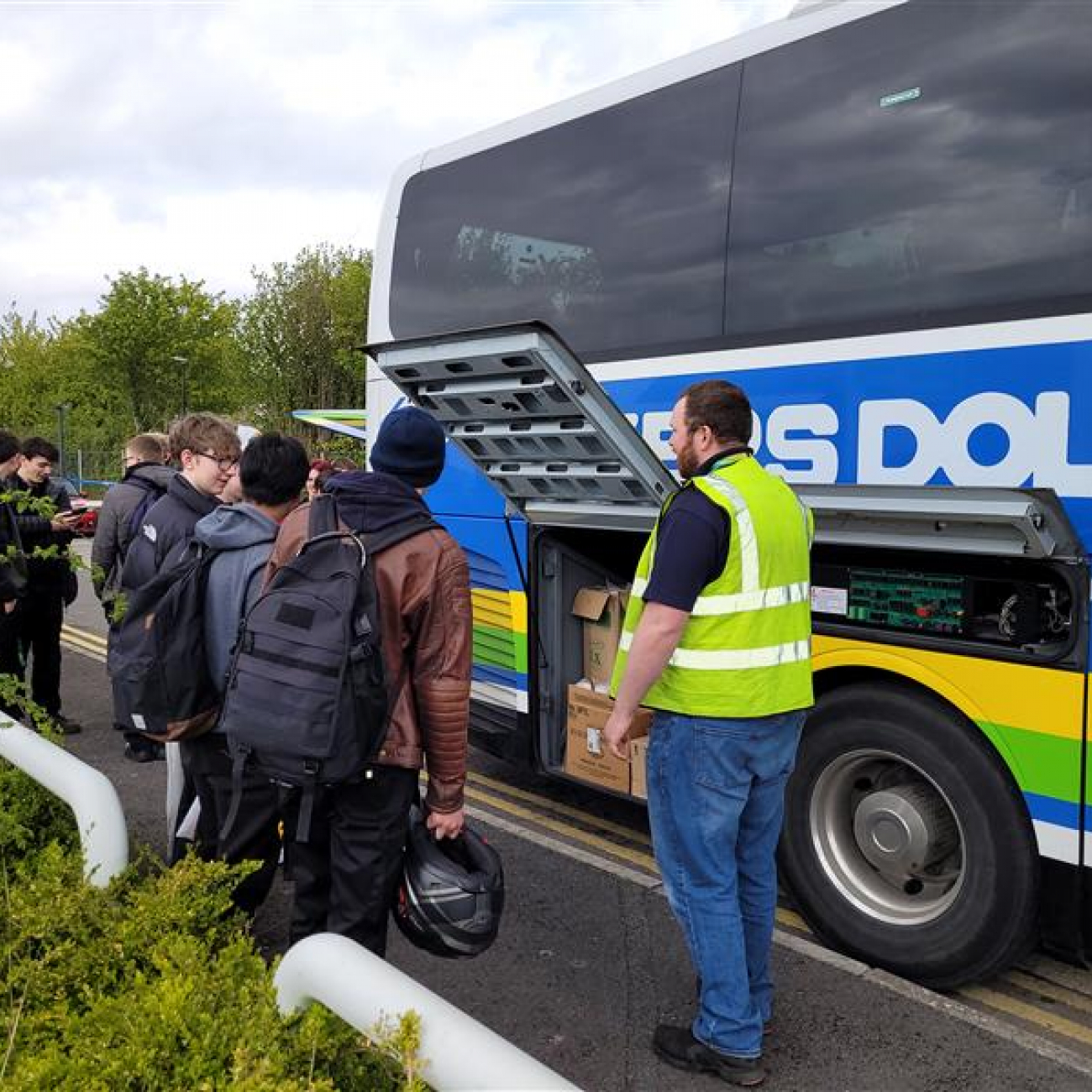 Bakers Dolphin team showing our students their coaches engine
