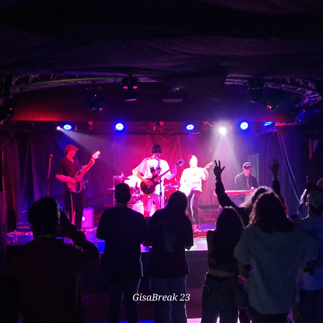 music students performing on the stage of a busy nightclub