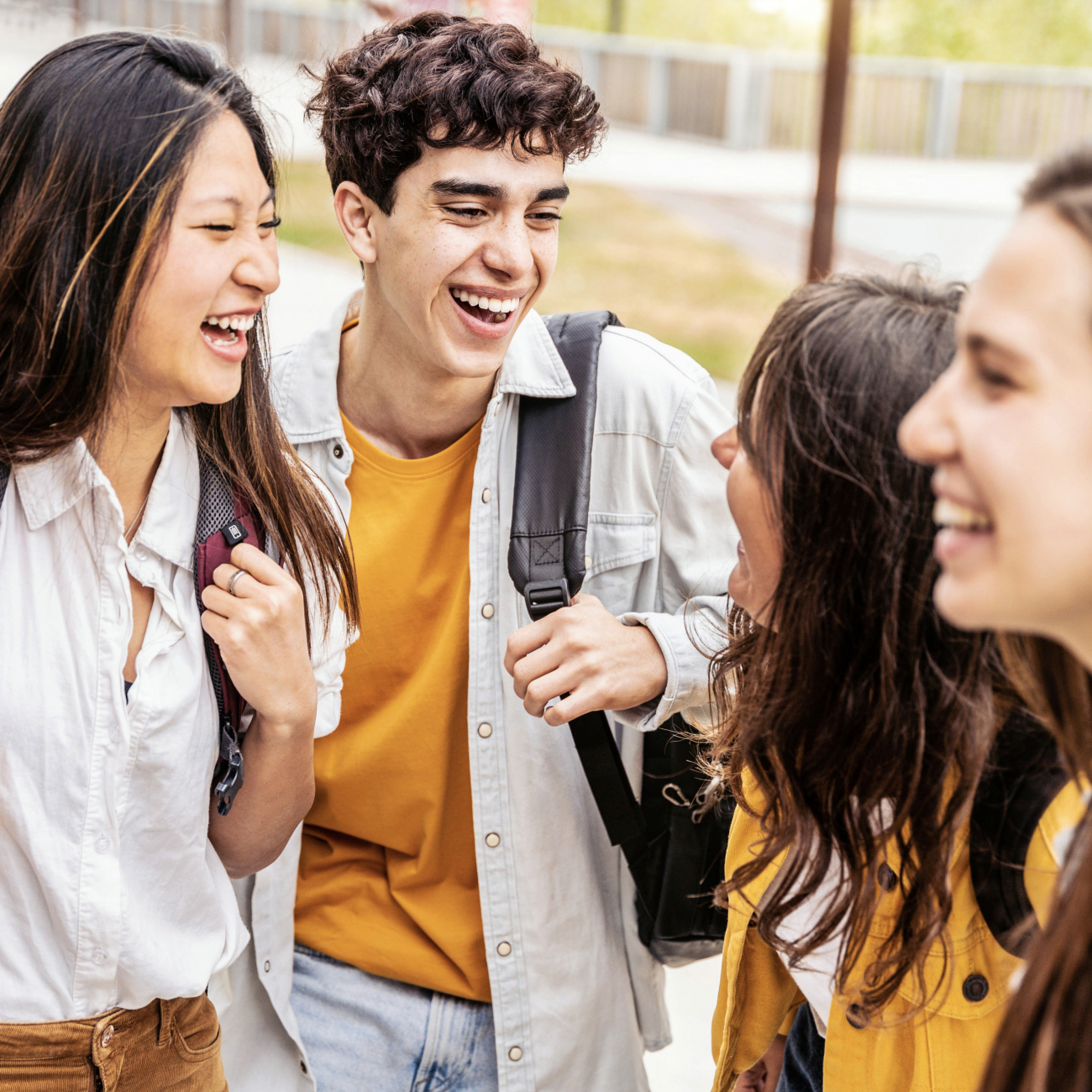 Students talking and laughing together in college campus