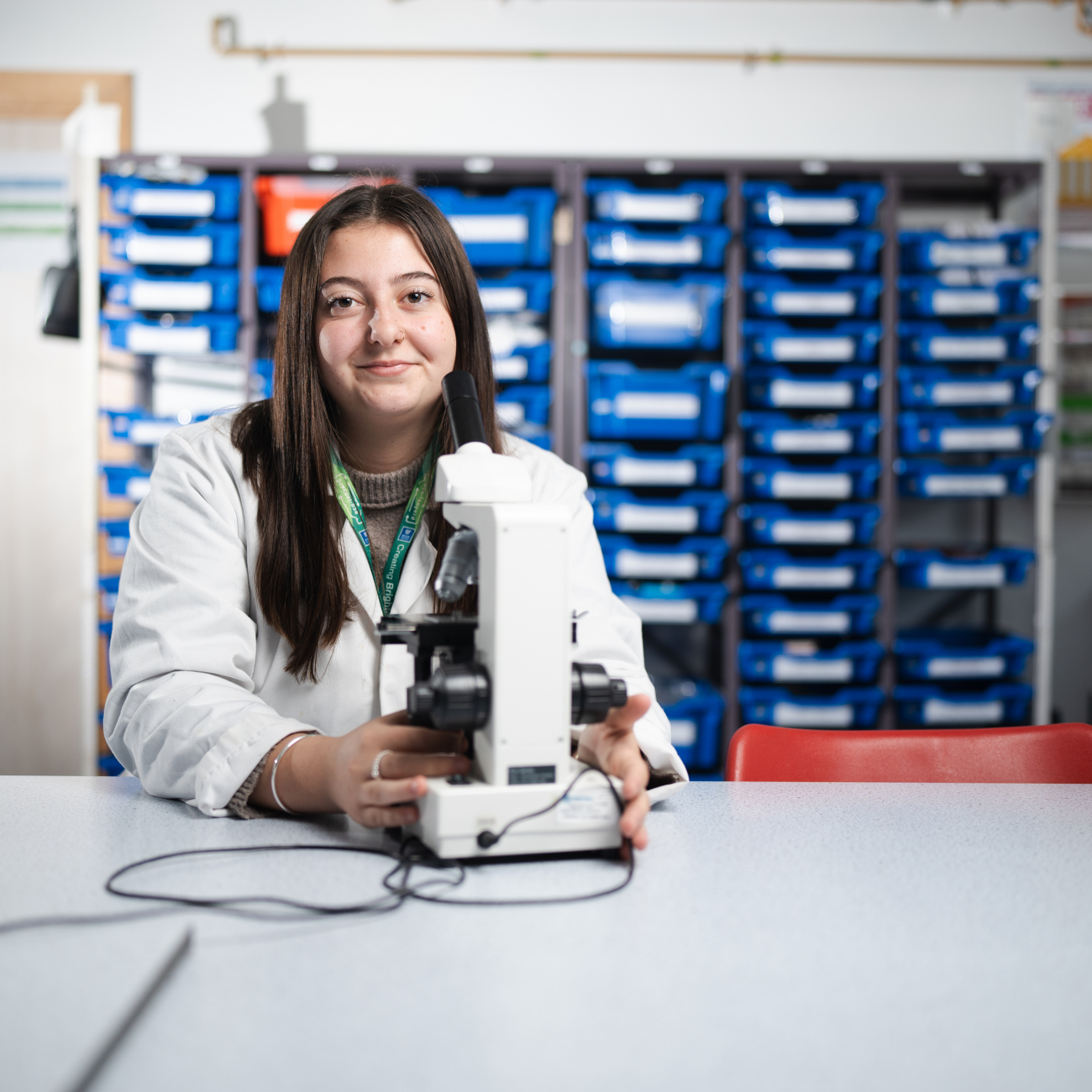 Student in lab smiling at camera