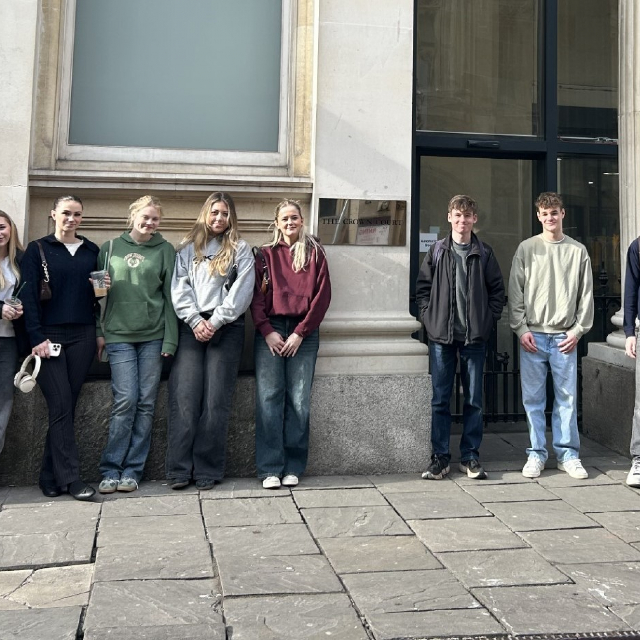 Group of 9 Law students standing outside Bristol Crown Court smiling