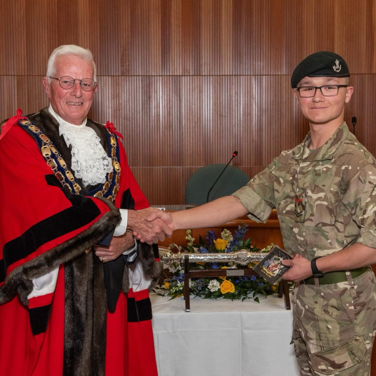 Dean wearing his army cadet uniform shaking hands with the Mayor