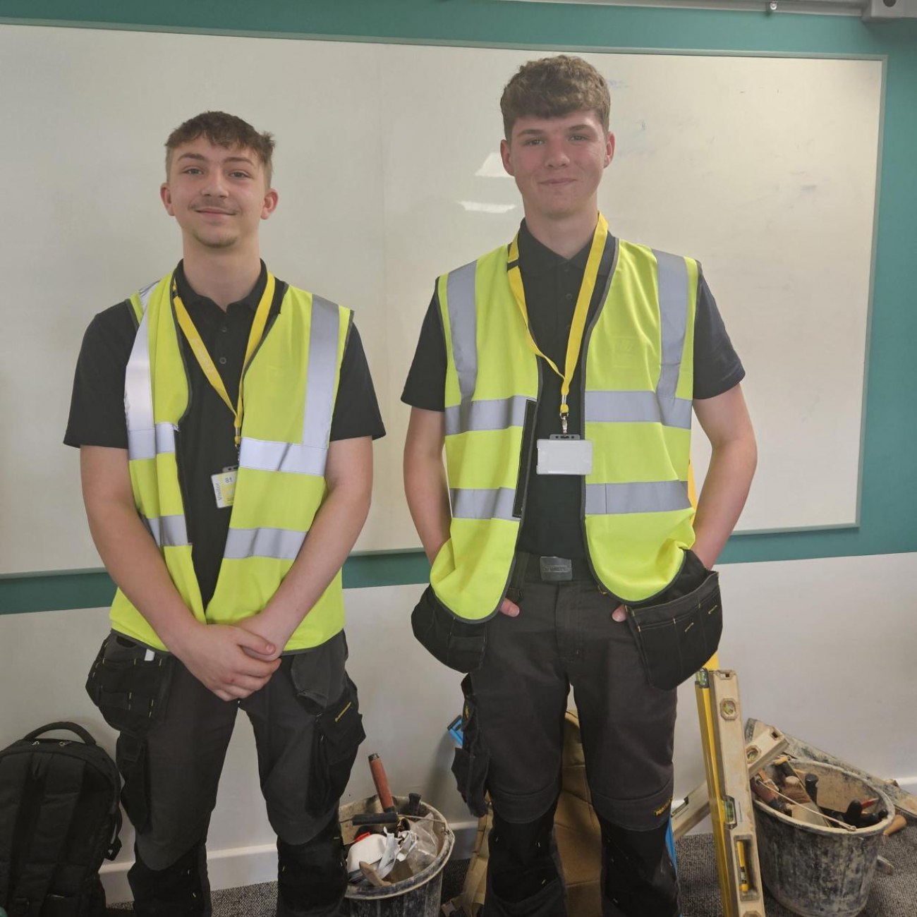 Max and Kieran standing next to each other smiling in their Hi-Vis jackets
