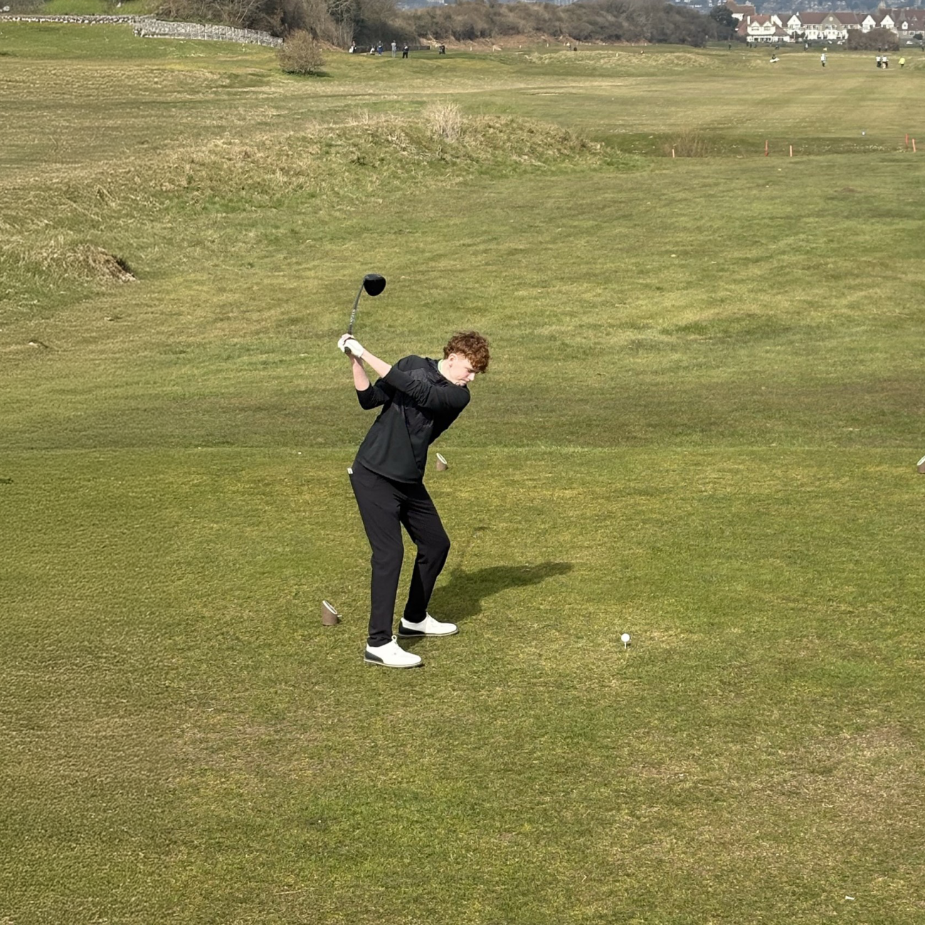 Troy taking a swing on the golf course