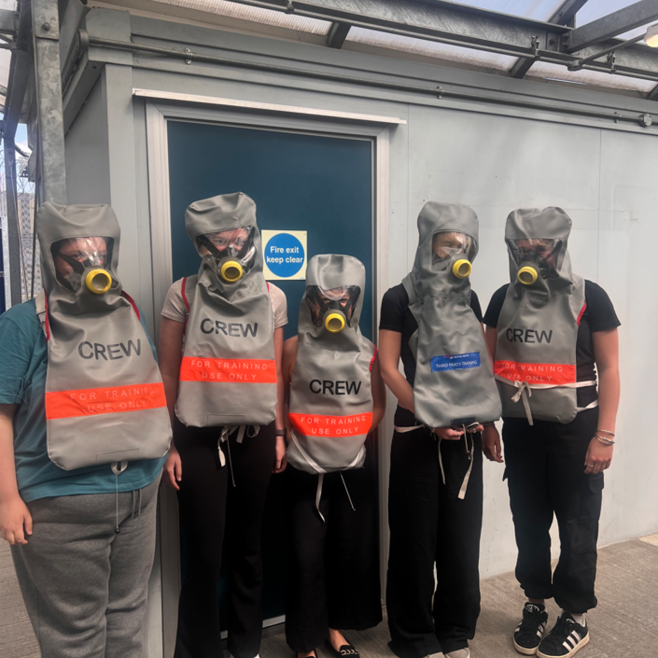 Students wearing lifejackets and oxygen masks