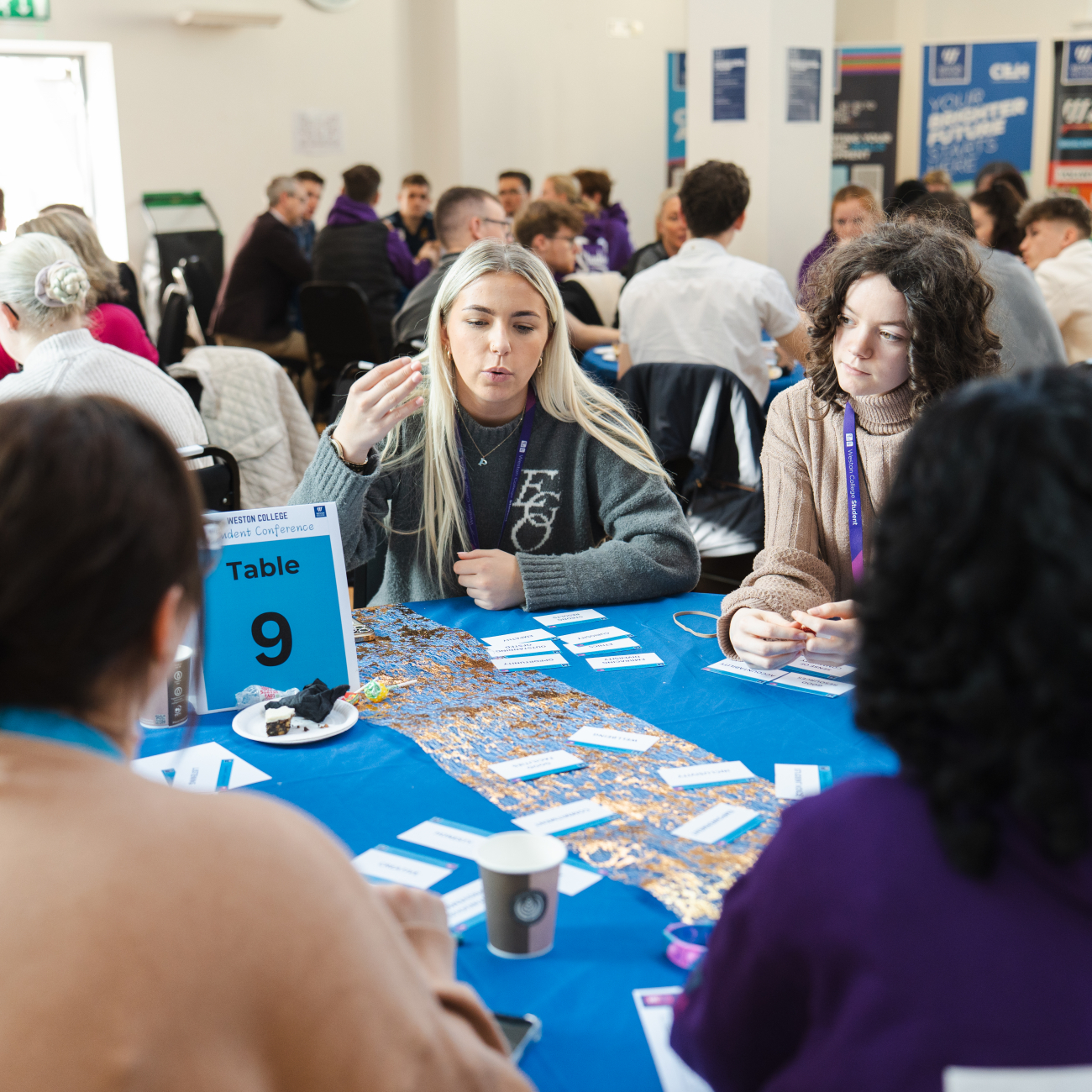Student conference, learners engaging sat at a table
