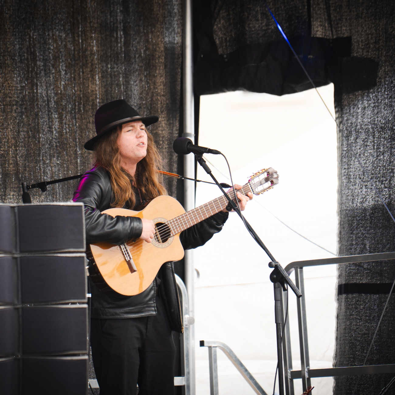 Student playing the guitar on stage