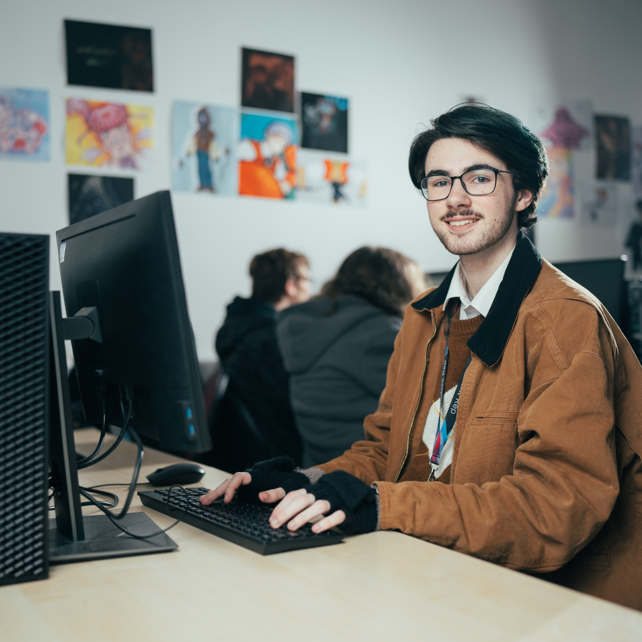 Digital Media student typing on a computer