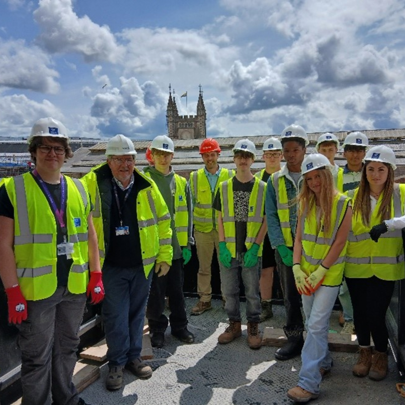 Students wearing HI-Vis jackets in the Welcome Building construction site